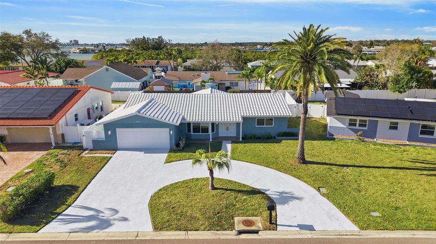 Just one mile from Madeira Beach, this fully renovated three-bedroom, two-bathroom ranch-style home is ready to move in with no HOA restrictions. New hurricane-proof windows and a sliding glass door open to a bright Florida room. The kitchen features new cabinets and appliances, and the home includes a cozy fireplace and a fully fenced backyard perfect for relaxing. A tile roof installed approximately five years ago and a two-car garage with new epoxy flooring add durability and style. Flexible rental options make it ideal as a personal retreat or investment property.