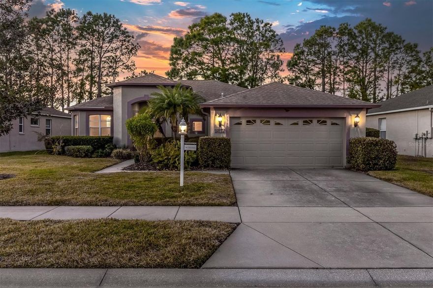 ENJOY SPECTACULAR SUNSETS IN YOUR DESIRABLE HERITAGE SPRINGS HOME! A quaint & cozy one-story home awaits, nestled in the active, amenity rich 55+ community of Heritage Springs Golf & Country club. Live the maintenance free Florida lifestyle in this home spanning 2206 sqft offering 2 bedrooms, 2 bathrooms, plus sunroom, 2 car garage. One of the seller’s favorite aspects of the home is the parklike view of trees, pond and nightly sunsets. No Flood zone! The home offers newer roof updated in 2018 with lightning rods, exterior paint 2022, AC 2008, gutters and hot water heater 2023. Once you enter through the decorative glass inlay front door, you are greeted by a freshly painted interior with Sherwin Williams City Loft throughout. To the left is a formal dining room with large window. As you enter the main living area you are greeted by an inviting atmosphere for gatherings and entertaining. The open-concept layout seamlessly connects the living, dining, and kitchen areas, creating an ideal space for easy & practical living. A grand living room with high ceilings provides an open space to relax and entertain overlooking the nature views. A galley kitchen provides ample cabinet & counter space, pantry, refrigerator, microwave, dishwasher and electric range. A granite breakfast bar and a casual breakfast nook adjacent to the kitchen afford multiple seating options for causal dining. The generously sized Primary bedroom offers large windows with views overlooks the tranquility of trees and pond. A spacious ensuite provides dual sinks, walk in shower and large walk in closet. A second well-sized bedroom is perfect for guests with a convenient full bathroom with tub/shower combo. A spacious laundry room with included washer/dryer and utility sink + cabinets offers extra storage. Enjoy 336 sqft Sunroom under roof & air conditioned overlooking the breathtaking views of pond, trees, birds and sunset can be enjoyed year round! Lawn care is included in the $150 per mth HOA to Twin Lakes Village. At the heart of the community is an impressive 20,600-square-foot clubhouse offering inviting social spaces, arts and crafts studios, a library, billiards room, and a Performing Arts Center with live entertainment and year-round events plus a full-time lifestyle director and concierge team curate a wide range of experiences within the community and traveling. Residents enjoy on-site dining at the restaurant and sports lounge, casual gatherings at the bar, and a robust calendar of clubs and activities that foster connection and community. An active lifestyle is encouraged by the 18-hole championship golf course featuring a pro shop and instruction, Har-Tru tennis courts, a heated pool and spa, and a well-appointed fitness center all covered by the $313 Master HOA fee. This home is situated close to shopping, dining, healthcare, beaches, Tampa International Airport & Downtown Tampa. With exceptional amenities, a beautiful view, and a welcoming sense of community, this home checks all the boxes. This is HOME!