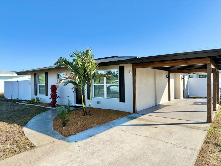 CUSTOMIZED HOME with over $100,000 in RECENT UPGRADES! Not your average home, move in this home confidently with peace of mind knowing everything is new! Currently operating as a SUCCESSFUL AIRBNB generating over $24,000 in DOCUMENTED ANNUAL INCOME, with potential to reach $32,000+ annually. This beautifully updated 2-bedroom, 2-bath residence shines inside and out, beginning with a NEW 2023 METAL ROOF with an estimated 50-year lifespan (good to 2073) and a NEW 2024 AC system. The vinyl privacy-fenced backyard enhances curb appeal while offering ample side yard space for RV or boat storage — a rare find! NO HOA, NO DEED RESTRICTIONS! Inside, enjoy laminate flooring throughout, designer lighting, and a welcoming living room highlighted by a custom plank accent entertainment wall, modern electric fireplace, 55” TV, and built-in ceiling surround sound — perfect for relaxing or entertaining. The kitchen is a true showstopper featuring granite countertops and backsplash, 2023 stainless steel appliances, trendy gold hardware, farmhouse sink, shaker-style cabinetry, an eat-in dinette, and plenty of space for multiple cooks. CITY WATER, CITY SEWER! A peaceful backyard view completes the space. The spacious primary suite offers private lanai access, a generous closet with flat two-panel doors, and a luxury en-suite bath showcasing double shower heads, custom built-ins, and rich cabinetry — truly the epitome of custom elegance. The guest bedroom comfortably accommodates visitors with a mounted TV, decorative ceiling fan, and spacious closet, sharing the beautifully updated secondary bath. Additional highlights include: • Inside laundry with matching washer/dryer and steamer option • 2023 tankless hot water heater • NEW 2024 ELECTRICAL • Hard-wired SECURITY CAMERA SYSTEM W/ AUDIO & RECORDING • 2023 double-pane HURRICANE RATED IMPACT WINDOWS, SLIDING DOORS & EXTERIOR DOORS • Public utilities • NO deed restrictions The screened lanai is ideal for morning coffee or evening cocktails, complete with a pre-installed TV mount — your own private retreat. Option to purchase furniture available, making this a true TURNKEY opportunity.  Located just minutes from two public boat ramps, Port Charlotte Beach, Kiwanis Park, Lakeview Park, Sunseeker Resort, downtown Punta Gorda dining and shopping, and Punta Gorda Airport. Seller is open to trading up or down for another local home. Schedule your private showing today — this one truly stands out!