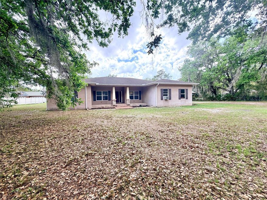 Welcome to your own private retreat in the heart of Plant City! This peaceful 3.55-acre property includes a main house and a separate, detached mother-in-law guest house, offering the ideal combination of space, privacy, and multi-generational living, with a total of 5 bedrooms and 4 bathrooms. The main house, built in 2017, boasts 2,198 square feet of spacious living, including three bedrooms, two bathrooms, and a two-car garage. The mother-in-law guest house features 864 square feet, two bedrooms, two bathrooms, and a wooden deck porch. The main house is designed for indoor and outdoor comfort and relaxation, with an open-concept floor plan that includes a large, screened, covered lanai ideal for entertaining family and friends, as well as ample space for your pets. The lovely, bright, expansive interior features beautiful kitchen cabinetry, granite countertops, bar seating, stainless steel appliances, a separate dining area, a utility room with a washer and dryer, and ceramic planks throughout. The roomy, open-concept layout connects the living room, kitchen, and dining area into one inviting space, making it ideal for gatherings, watching TV, or spending quality time with family and friends. The beautiful master bedroom suite is spacious and private, featuring a walk-in closet and a large walk-in shower. On the opposite side, you will find two additional bedrooms that are also generous in size, complete with double closets that are perfect for teenagers and additional storage.  The detached mother-in-law guest house, built in 2017, spans 864 square feet and features two bedrooms, two bathrooms with one walk-in shower and the second with a bathtub, a fully equipped kitchen, and a combined living and dining room with a rear wooden deck porch for grilling and entertaining. This home's setup is ideal for hosting larger families or earning rental income to offset expenses. This property beautifully combines a peaceful country setting with modern convenience. Plant City is widely known for its vibrant agricultural roots and small-town charm- minutes from the Florida Strawberry Festival, favorite spots like Keel & Curley Winery, Parkesdale Farm Market, Dinosaur World, and nearby Edward Medard Conservation Park offering fishing, hiking, and horseback riding. Quick access to I-4, this location offers an easy commute to Tampa and Lakeland, as well as easy access to all that Florida's countryside has to offer: shopping, dining, entertainment, and local attractions.