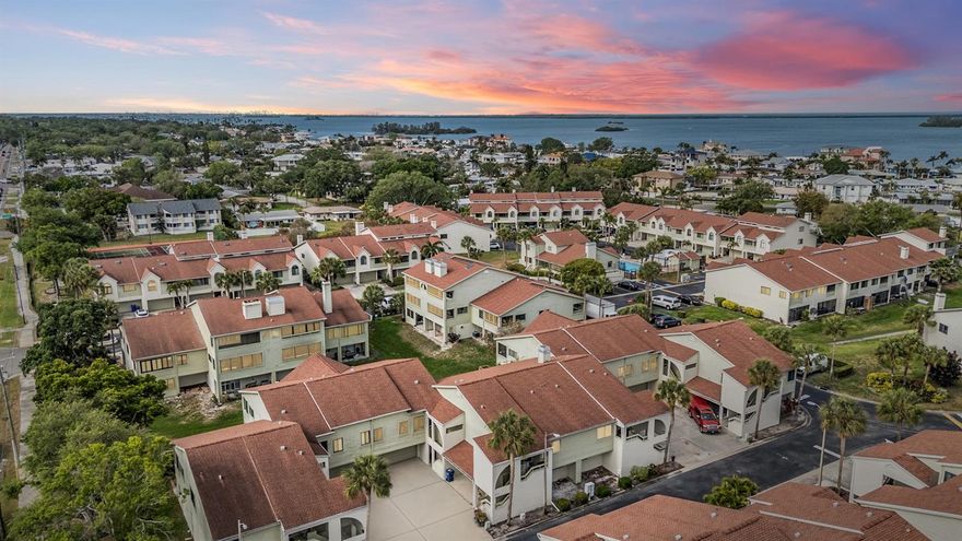 Perfectly positioned in one of Dunedin’s most sought-after locations, this 2-bedroom, 2-bath townhome offers the ideal blend of comfortable living and an unmatched coastal lifestyle. Nestled just minutes from the heart of downtown, you’ll enjoy easy access to a vibrant scene filled with locally loved restaurants, lively bars, boutique shops, and year-round festivals that give Dunedin its unmistakable charm. Outdoor enthusiasts will appreciate the proximity to some of the area’s most treasured green spaces, including Hammock Park, Weaver Park, and Edgewater Park—all offering scenic waterfront views, walking trails, and peaceful places to unwind. Just a short drive or bike away, the award-winning shores of Honeymoon Island State Park and Caladesi Island State Park invite you to experience some of Florida’s most beautiful beaches. For those who enjoy an active lifestyle, the property is adjacent to the Pinellas Trail which spans over 45 miles, creating a unique, car-free corridor perfect for biking, walking, and exploring from St. Petersburg to Tarpon Springs. Dunedin is also rich in arts and culture, with destinations like the Dunedin Fine Art Center, Ruth Eckerd Hall, the Capitol Theatre, and The BayCare Sound concert venue all just a short drive away. Inside, the home features a functional and inviting layout while capitalizing on the natural light with hurricane rated sliders and windows.  The renovated open kitchen features stainless steel appliances, granite countertops, bar seating and storage galore.  Two spacious bedrooms each have their own full baths. The primary retreat features a dual vanity, spacious shower, walk-in closet and sliders to the outdoor balcony.  A standout feature is the oversized 2+ car garage, offering exceptional storage and flexibility. The lower level provides additional living space with it's own a/c unit, not included in the listed square footage—ideal for a home office, gym, hobby room, or guest overflow. The community offers a perfect blend of amenities with a pool, spa, tennis courts and clubhouse. Monthly HOA fee covers trash, water, sewer, basic internet, basic cable, flood insurance, pool, all exterior repairs and maintenance and escrow reservesWhether you’re seeking an active coastal lifestyle or a peaceful retreat with access to everything, this home delivers the best of Dunedin living with convenient access to downtown Tampa and Tampa International Airport.