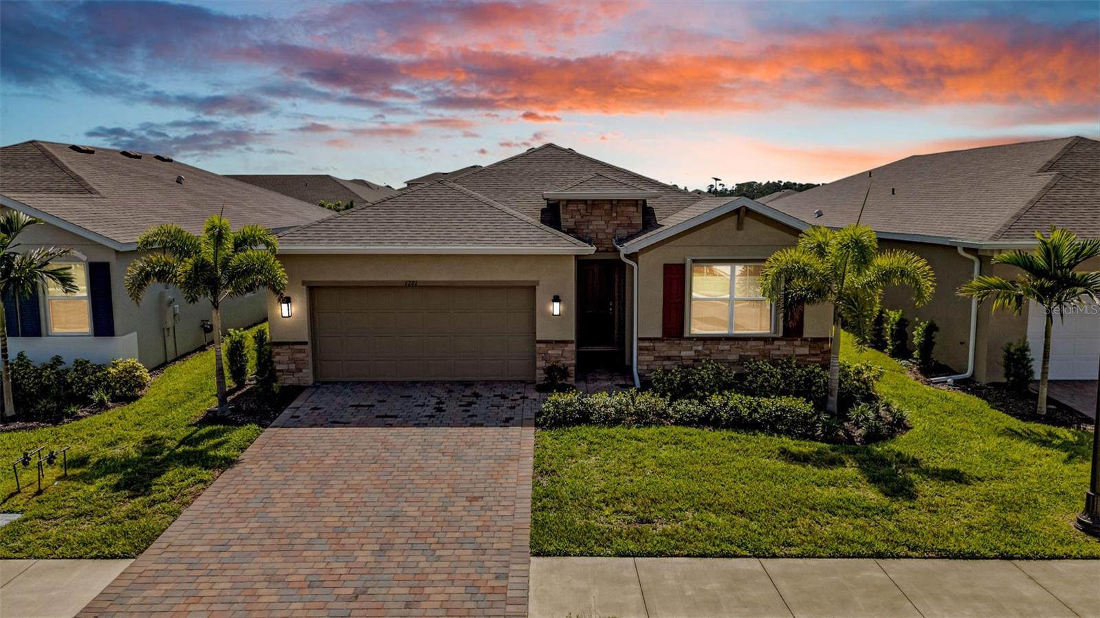 Step inside and embrace the relaxed, resort lifestyle of The Cove at West Port in Port Charlotte. This 4-bedroom, 2-bath Delray model home has a light-filled, open-concept design with ceramic tile in the main living areas and soft carpet in the bedrooms. A double set of sliding glass doors and an abundance of windows bring in the Florida sunshine, filling the kitchen, dining, and living spaces with natural light. The kitchen takes center stage with white cabinetry, granite countertops, stainless steel appliances, and a large island that flows into the dining and living areas, creating an inviting space for everyday living or entertaining. One of the bedrooms offers flexible use and could easily serve as an office, den, or guest room. Hurricane shutters provide peace of mind, while a brick driveway and a brick-paved screened lanai add charm and durability. Sliding doors open to the lanai with peaceful pond views, creating a quiet place to enjoy your morning coffee or unwind at the end of the day. Residents of The Cove at West Port enjoy exclusive access to an amenity campus with a clubhouse, resort-style pool, pickleball and bocce ball courts, a pet park, and more. HOA fees include lawn care and community upkeep, making it easy to enjoy everything this vibrant community has to offer. Conveniently located near Hwys 41 and 75, this home keeps you close to shopping, dining, entertainment, and the beautiful Florida beaches.