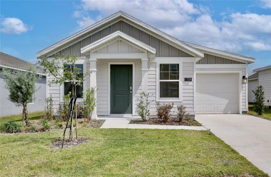 One or more photo(s) has been virtually staged. Experience modern Florida living in this recent construction 2024 build, located in the serene Peace Creek Reserve community of Winter Haven. Perfectly suited for a first time homebuyer or anyone looking to transition into a more manageable, contemporary space, this haven offers both style and convenience. The home’s curb appeal is defined by its clean, modern lines and manicured landscaping. Situated on a quiet street, this property provides a retreat from the hustle and bustle. The backyard offers a blank canvas, perfect for weekend gardening or creating your own outdoor sanctuary. Step inside to find an expansive main living area where the kitchen, dining, and family rooms flow together seamlessly. The vaulted ceilings and tile flooring create an airy atmosphere that feels much larger than its footprint. The windows invite natural light to bounce off the walls, enhancing the bright and inviting feel of the home. The modern kitchen is a chef’s delight, featuring a large peninsula with breakfast bar seating, solid surface countertops, and sleek stainless steel appliances. Whether you are hosting a dinner party in the adjacent dining area or keeping an eye on the family while preparing a meal, this open layout ensures you are always part of the conversation. The home features three well appointed bedrooms designed for rest and relaxation. The primary suite offers direct access to the backyard and a spacious walk in closet. It shares a stylishly updated bathroom with the hallway, which features a modern glass enclosed shower with elegant tile work and a spacious vanity. A second bedroom also includes a walk in closet, providing ample storage. For added convenience, the home is equipped with a dedicated laundry closet complete with a stackable washer and dryer, as well as an attached one car garage. Residents of Peace Creek Reserve enjoy premium community amenities, including a sparkling resort style pool and a vibrant playground, along with picnic areas. Beyond the community gates, you are in the heart of the "Chain of Lakes" city. You’ll be just minutes away from world class attractions like LEGOLAND Florida Resort and the Peppa Pig Theme Park. Outdoor enthusiasts will love the proximity to over 26 linked lakes, perfect for boating, fishing, and kayaking. Commuting is a breeze with easy access to highway 27 and I-4, placing you just 30 miles from the magic of Walt Disney World. Experience every detail of this modern turn-key home through the immersive 3D virtual tour, and schedule your private showing today!