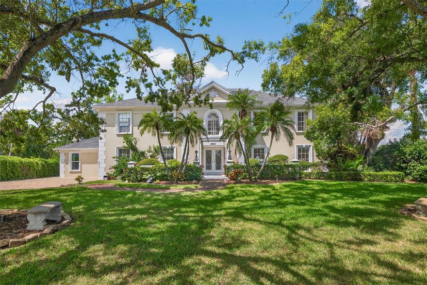 Timeless architecture meets refined modern living in this extraordinary Georgian-style Luxury pool home, which is gracefully positioned along the 15th fairway of the sought after Feather Sound Country Club. This beauty is boasting 5,312 square feet of impeccably designed living space and embodies sophistication, comfort, and the enduring appeal of one of Tampa Bay’s most coveted golf course communities. From the moment you arrive, the home’s stately façade, symmetrical proportions, and classic entryway set the tone for the elegance within. A grand foyer welcomes guests viewing each custom detail. Every room is curated to create an atmosphere of understated Luxury. The formal living & family rooms provide the perfect stage for elegant entertaining, with fireplaces, intricate moldings, and Hurricane Rated French doors that open to views of manicured lawns and emerald fairways. The heart of the home is the expansive chef’s style kitchen that includes professional-grade stainless appliances, custom wood cabinetry, Quartz countertops, large walk-in pantry, built-in seated breakfast nook, and a large peninsula that all combine functional and beautiful space. The adjoining dining room, bathed in natural light, invites casual gatherings while offering seamless transitions to the additional living areas. The main floor features a complete bedroom and full bathroom that would make for a remarkable mother in law suite or as a multi purpose room! This home comes equipped with storage options like the walk in closet on the 1st floor. The residence features 6 spacious bedrooms, 5 full baths that include separate full bathrooms to ensure comfort and privacy for both residents and guests. The primary bedroom is a sanctuary unto itself, featuring a private sitting area that can be used as a craft room, home office or nursery, spa-inspired ensuite bath with a large walk-in shower, dual vanities, ample storage, and an expansive custom closet with built-in organizing system. The additional bedrooms are equally well-appointed, each with natural lighting and walk-in closets. A versatile main floor bedroom with attached full ensuite provides flexibility for an in-law suite, home office, or study. Whether hosting intimate gatherings or grand celebrations, this home effortlessly accommodates every occasion with grace. Outdoors, a world of relaxation unfolds. The resort-style pool and spa surrounded by lush landscaping and brick decking are designed for outdoor dining and sunset cocktails, all while overlooking sweeping views of Feather Sound’s rolling greens. The artificial turf offers both beauty and easy maintenance, while the golf course backdrop ensures an ever-changing panorama of Florida’s natural splendor. Additional highlights include a 2-car garage, spacious closets, and Hurricane Rated Windows & Doors. Beyond the home itself, Feather Sound is celebrated for its central location between Tampa and St. Petersburg, offering an easy commute to downtown business districts, award-winning beaches, and Tampa International Airport. Membership opportunities at Feather Sound Country Club provide access to championship golf, tennis, fitness, and fine dining—all just steps from your backyard. This classic Georgian style is more than a home; it is a lifestyle defined by elegance, leisure, and timeless beauty combined and nestled in Tampa Bay.