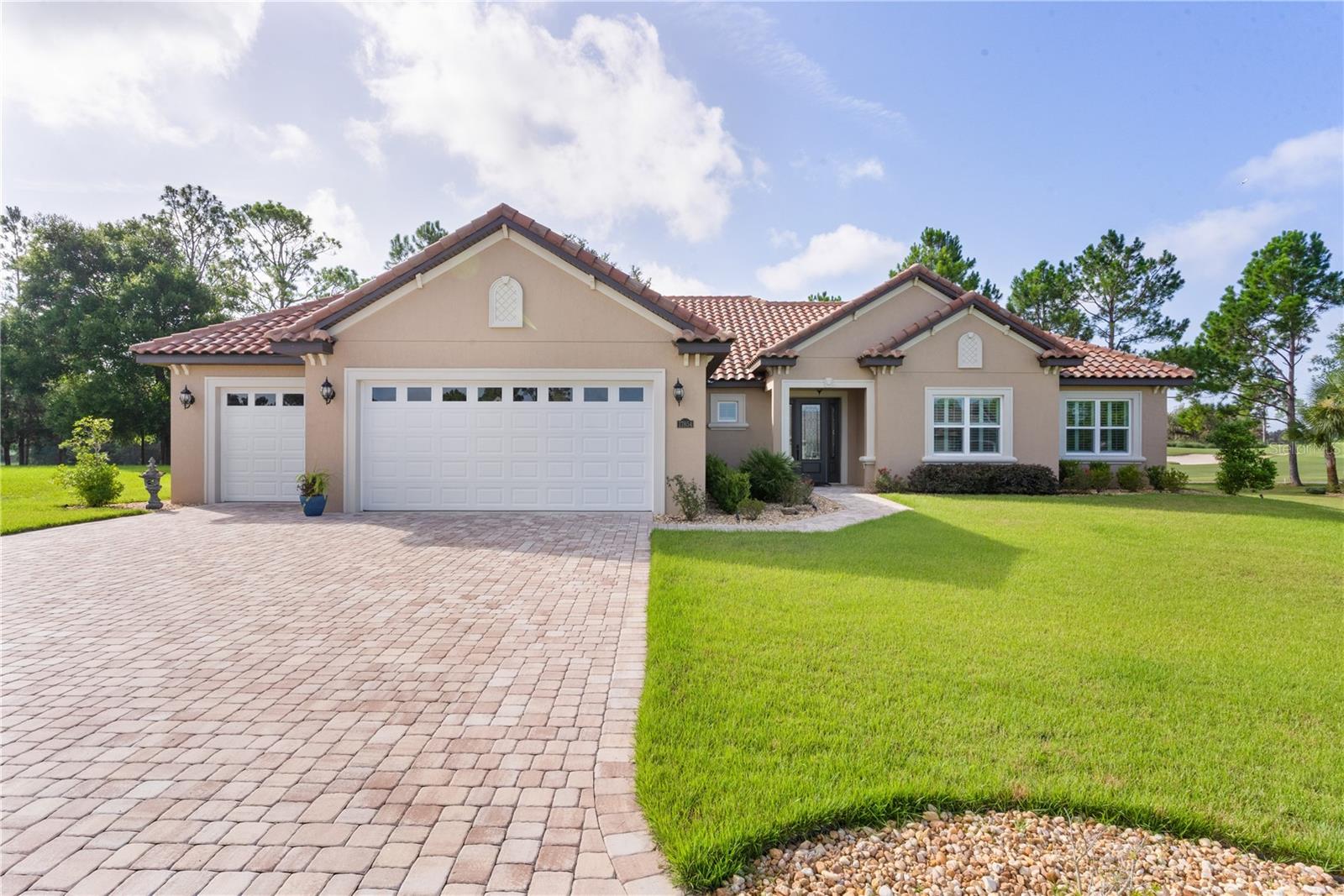 Welcome to the Gated Community of Juliette Falls. The Stunning 2023 Designer “Deluxe Ruby” home, built by Crouch Homes LLC is located on the 1st FAIRWAY of the Award-Winning Juliette Falls Golf Course and is the Top 10 Courses in the Nation and Top 3 in Florida. This designer home features 4 bedrooms and 2.5 bathrooms, 3-Car Garage spanning 2,392 square feet, Golfer Enthusiast will want this VIEW OF THE GOLF COURSE, enjoy a cup of coffee or a glass of wine while enjoying the golfers hit the first tee. The 15x18 COVERED LANAI and the Designer PAVER PATIO full length of rear of home are great places to entertain. Upon entering the home, you will be captivated by the airy OPEN FLOORPLAN, PLANTATION SHUTTERS, highlighted by a spacious 20' x 22' Living room adorned with impressive 10-foot COFFERED CEILINGS featuring track Lighting. The Kitchen boasts custom Cabinetry with Soft-Close doors, Under-Cabinet Lighting with under-Crown Molding, QUARTZ Countertops, a stylish TILE Backsplash, STAINLESS STEEL Appliances, a BUILT IN OVEN and Microwave, a cozy coffee bar, and a well-appointed dining room. The Primary Suite, measuring 19' x 15', offers TRAY CEILING, DUAL WALK IN CLOSETS, En-Suite Bathroom with DUAL VANITIES with under-cabinet lighting, GRANTITE COUNTER, a luxurious TILED WALK-IN SHOWER. and Private Water Closet. The Guest bedrooms provide generous proportions and sufficient closet space. The Guest Bathroom also includes Custom Cabinets with under-cabinet lighting, GRANITE Countertops, and TILED WALK-ON SHOWER. For added convenience, the Laundry Room measures 10' x 14' and includes a built-in sink and extra counter space for laundry organization and added PANTRY STORAGE. The half bathroom features Custom Cabinetry with under-cabinet lighting and GRANITE counters. No home would be complete without a PAVER DRIVEWAY with a 3-CAR GARAGE, which showcases beautiful EPOXY Floors, ELECTRIC CAR CHARGER and ample space for vehicles and recreational equipment. The Attic is equipped with Pull-Down Stairs and is fully decked for additional storage. This home is loaded with upgrades, including LAMINATE FLOORING throughout the main living areas, 6" CROWN MOLDING, an upgraded front door, recessed LED Lighting, and 8-foot tall Interior Doors. The local Pro-Shop has golf apparel, golf clubs, golf balls, shoes, bags, and golf-themed gift items. Juliette Falls Bar & Restaurant has wide variety of delicious options daily and 1st Friday Evenings. Stop at the Driving Range and visit the Blue Bar, also known as the "19th hole" after your round and cool off with for an ice cold beer! Juliette Falls is Located just 15 miles from Ocala and the renowned World Equestrian Center, you can discover the charm of Dunnellon—a town rich in history, culture, and natural beauty. Experience the breathtaking scenery of Rainbow Springs State Park, where you can float down the world-famous Rainbow River. Golfer Enthusiast Dream Location.