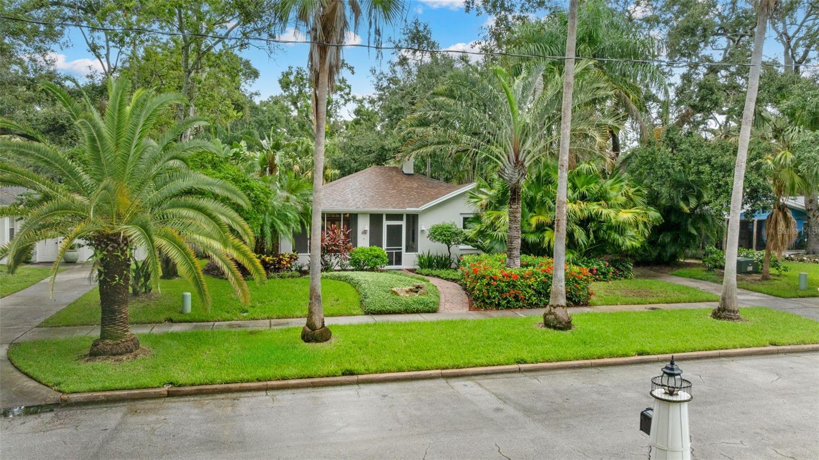 5 photos have been virtually staged. Welcome to Dunedin, the gem of the Gulf Coast! Don't miss this opportunity to live in Dunedin’s most exclusive neighborhood, in this delightfully updated 3 bedroom, 2 bath historic home on desirable Aberdeen Street. Enter this meticulously landscaped home through its screened lanai and be transported to Old Florida beauty. The lanai is the perfect place to sip a beverage while chatting with neighbors. French double doors lead you into the cozy living room with original parquet flooring and tons of natural light. Pass the stunning fireplace and head to the breakfast nook and refreshed kitchen. More natural light pours through the skylight and bounces off of the new quartz counters. Take in the perfect blending of timeless architectural charm with modern luxury as you stroll through the home which includes the addition of a primary suite with a walk in closet. This property is not only a sanctuary but it also offers peace of mind with its hurricane-resistant impact windows (2018) and a brand-new roof (2025). Other major system updates include two A/C units (2020 & 2024) and a new hot water heater (2024). The perfect Florida retreat, relax in the lush backyard that offers privacy and plenty of room for a pool oasis or stroll to the end of the street and watch the evening sunset on the water off beautiful Edgewater Drive. Ride your bike down the Pinellas Trail to the award winning Honeymoon Island or Clearwater Beach. Jump into your golf cart, walk if you prefer, and cruise to the quaint Downtown Dunedin lined with shops, restaurants and Florida’s premier micro-breweries. There’s a new festival or market most weekends. With all that Dunedin has to offer, make this exceptional property in one of Florida's most coveted neighborhoods your own, today! Buyer premium, preferred lender and seller offering to assist buyer with a rate buy down if desire! Inquire with your agent for details.