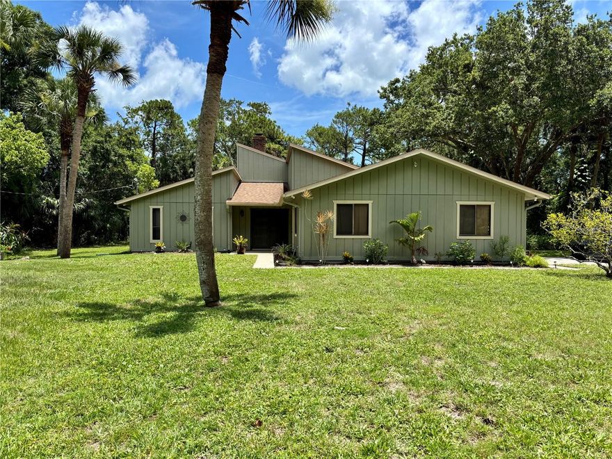 2.5 ACRE HOME! CUSTOM! ONE OWNER! PRIVATE, SECLUDED Homesite —all within the city limits of Port Orange! HOMESITE Includes a 36 X 45 POLE BARN equipped with electricity!  Ceilings high enough to STORE AN RV!  NO HOAS!!  Experience FREEDOM in this CUSTOM BUILT 1980s HOME!  SPECIAL FEATURES include:  Flooor to Ceiling GORGEOUS STONE FIREPLACE in the expansive Great Room!  Jack and Jill Bathrooms in between each oversized bedroom has a SPA LIKE Feel!  Unique elevated Diningroom!  HUGE MASTER BEDROOM with LARGE WALK-IN CLOSET! BONUS ROOM with so many possibilities!  MODERN UPGRADES include: ROOF in 2021.  Kitchen remodel in 2024.  This is a MUST SEE!!!  Offering the tranquil feel of country living with the convenience of city amenities, this rare gem combines space, privacy, and location in perfect harmony. This one-owner estate features over 2,500 sq ft of living space, thoughtfully laid out for comfort and functionality. Nestled on a quiet, tree-lined lot, you'll enjoy serene surroundings, abundant wildlife, and room to expand—whether you envision a pool, garden, or guest house. Bring Your RV, BOAT, WORK TRUCKS, TOYS, etc...