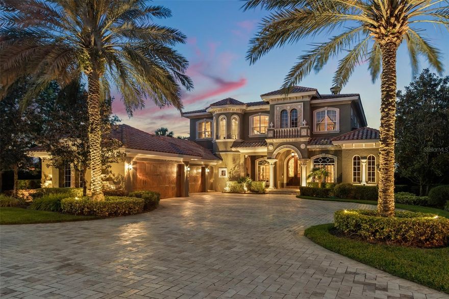 Welcome to Villa Venecia, a privately gated lakefront estate set amidst two lakes within the exclusive gated community of the Isles of Lake Hancock.  With 6 bedrooms, 6 full and 3 half baths and 8552 sq ft (12,391 total), this extraordinary Mediterranean masterpiece showcases only the finest craftsmanship and materials, exuding opulence in every detail.  Beyond the private electric driveway gates, distinctive verdant landscaping lines the long travertine driveway.  Built by Dave Brewer, Villa Venecia is nestled along the southern shoreline of Lake Hancock within an enclave of custom-built lakefront homes, ideally situated on pristine shoreline frontage with the lake’s most expansive water views.  At the entry, the handcrafted rustic mahogany and wrought iron doors open to polished travertine floors enhanced by a tile mosaic, flowing to a remarkable picture window where the infinity edge pool blends to long, dreamy lake vistas that invite.  Sensational choice Italian original paintings by local artist Joel Cook adorn the entrance, theater ceiling and entrance, wine room, outdoor spa, and kitchen range hood.   The Kitchen includes two custom-paneled Sub-Zero refrigerators with four freezer drawers, three Miele dishwashers, an industrial Wolfe range, and a large hidden pantry.   All main floor living areas and second floor balcony look out to the infinity pool and spa, surrounded by expansive covered outdoor living areas, complete with an outdoor kitchen, tv, and fireplace.    The exquisite main floor master wing includes a morning kitchen and opens to the poolside oasis overlooking the lake.  The wine cellar is accessed from the extravagant formal dining room.  The ten-seat theater is accessed from the kitchen and is equipped with a 5’x8.5’ screen and cinematic motifs, maintains the rich elements of the residence.  The main floor gym can be accessed from within or separately and includes outside showers.  The large game room features a beamed, tongue-and-groove cathedral ceiling, includes its own bar, and opens through sliding glass doors to the outdoor living area.  The entire pool deck area is surfaced by natural stone and offers stunning lake views. With TWO lakes—and docks—the custom dock and boathouse on Lake Hancock and the boathouse, deck and dock on the adjacent private man-made water ski lake, Villa Venecia avails the very best opportunities to fully enjoy Florida lake life. Lake Hancock is a chain of three lakes, pristine waters with miles of shoreline for boating, and is paradise for fishing and all water sports.  For water ski enthusiasts, one of only 15 memberships to the exclusive Isles of Lake Hancock Ski Club is available to access the world-famous man-made water ski lake across the street–with an additional large private boathouse as part of the membership.  Many top golf courses are nearby, including Isleworth, Keene’s Pointe, Disney, Orange County National, The Four Seasons, and West Orange. Shopping conveniences at Hamlin are only minutes away, and the Hamlin town center plans include docks for water access to restaurants, shops and a movie theater. All only minutes from downtown Winter Garden, Windermere, Disney and the world famous attractions of Orlando.