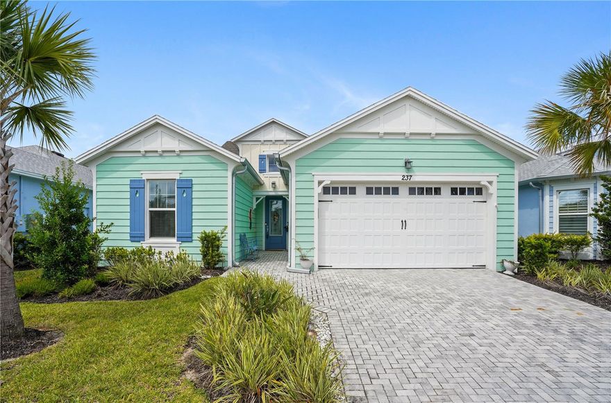 Don't miss the opportunity to own 237 Blue Starfish Place, a stunning 3-bedroom, 2-bathroom split-bedroom floor plan home located in the highly sought-after 55+ community of Margaritaville – Latitudes in Daytona Beach, FL. This home has been thoughtfully upgraded, blending luxury and coastal charm in every corner. From the moment you enter the open foyer, you’re welcomed into a spacious great room and kitchen area adorned with bright white crown-molded cabinetry, a beautiful herringbone tile backsplash, quartz countertops, and high-end stainless steel KitchenAid appliances, including a gas range. The kitchen is loaded with functionality thanks to custom pull-outs and ample storage space. The great room boasts a coffered tray ceiling with a shiplap inlay, crown molding, and plantation shutters that overlook an extended lanai—ideal for entertaining or enjoying peaceful Florida evenings. Flooring includes coastal-look laminate throughout the main living areas, tile in the wet areas, and plush carpet in the guest bedrooms for added comfort. Retreat to your primary suite, which features another coffered tray ceiling with shiplap detail, along with a spacious en-suite bathroom that includes a large walk-in shower. Every detail in this home has been carefully curated to provide both elegance and ease of living. All of this is located within a vibrant, resort-style community offering 5-star amenities such as three pools, a full-service restaurant, fitness center, pickleball courts, tennis courts, dog park, golf cart community, and more. Whether relaxing at home or enjoying the social lifestyle Latitudes has to offer, this home is your perfect island-inspired retreat!