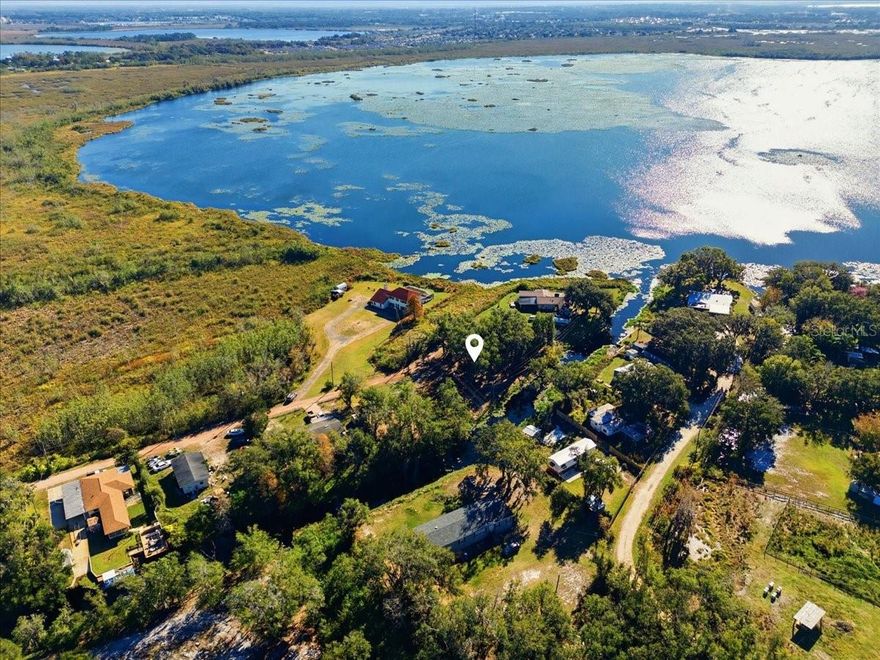 Beautiful Lake Lowery has a piece of paradise waiting for you. This waterfront property spans almost an acre of land (0.78 acres) and boasts 200 feet of lakefront. The land has been cleared for easy access to the water via a channel at the back of the lot, making it perfect for pontoon boats, bass boats, and jet skis. From the center of the property, you'll enjoy water views in three different directions. The lot features a mix of mature trees and open, sunny grassy areas. This location offers a true sense of being "away from it all," while still being just a few turns from shopping, doctors, restaurants, and entertainment. Electric, septic, and well are available on-site.