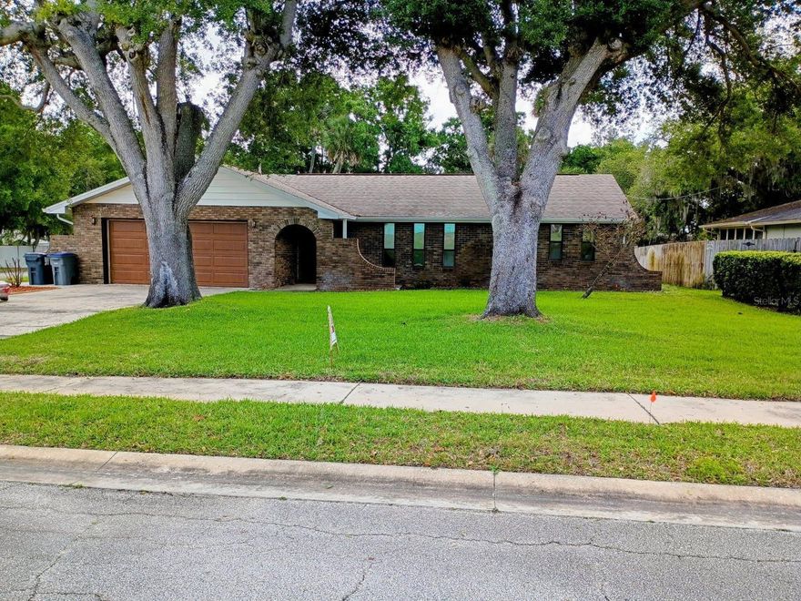 Beautifully maintained brick residence offering a desirable split-bedroom layout with a spacious primary suite and three additional bedrooms. A standout feature is the expansive enclosed porch under air, complete with large double-pane windows—perfect for enjoying serene backyard views year-round. The generous yard provides ample space for relaxation or entertaining. Ideally located just two blocks from the elementary school and minutes to shopping, parks, and the Indian River Intracoastal Waterway. Enjoy quick access to Canaveral National Seashore, an unspoiled beachfront just 20 minutes away, and nearby Kennedy Space Center, where you can experience rocket launches right from your own backyard. Move-in ready and perfectly positioned for both convenience and lifestyle.
