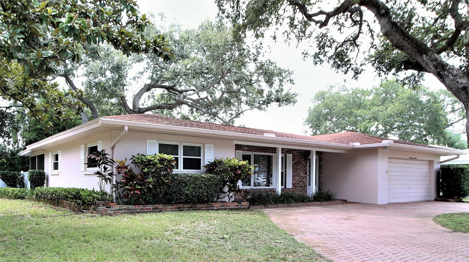 This beautiful 1651 sq/ft 3-bed/2-bath home has LOTS of charm! This home sits on a wooded corner lot with beautiful Live Oak shade trees, FENCED YARD circular drive, large 2-CAR GARAGE with one wall full of built-in storage cabinets and overhead storage, SPLIT BEDROOM FLOORPLAN, Save $$$ on electric - AC is newer and the windows are upgraded insulated glass for energy efficiency. This home has lots of closet space and beautifully POLISHED TERAZZO FLOORING THROUGHOUT. The kitchen is bright and features lots of cabinets, cook top and newer stove and dishwasher. You’ll love to relax or entertain in the large living room or back Florida room which opens out to the spacious screened porch. Best of all, it’s a short drive to the beaches, restaurants, shopping, entertainment, MacDill AFB, downtown Clearwater, Pinellas Int’l Airport and Tampa. ***Owner would consider purchase after lease***