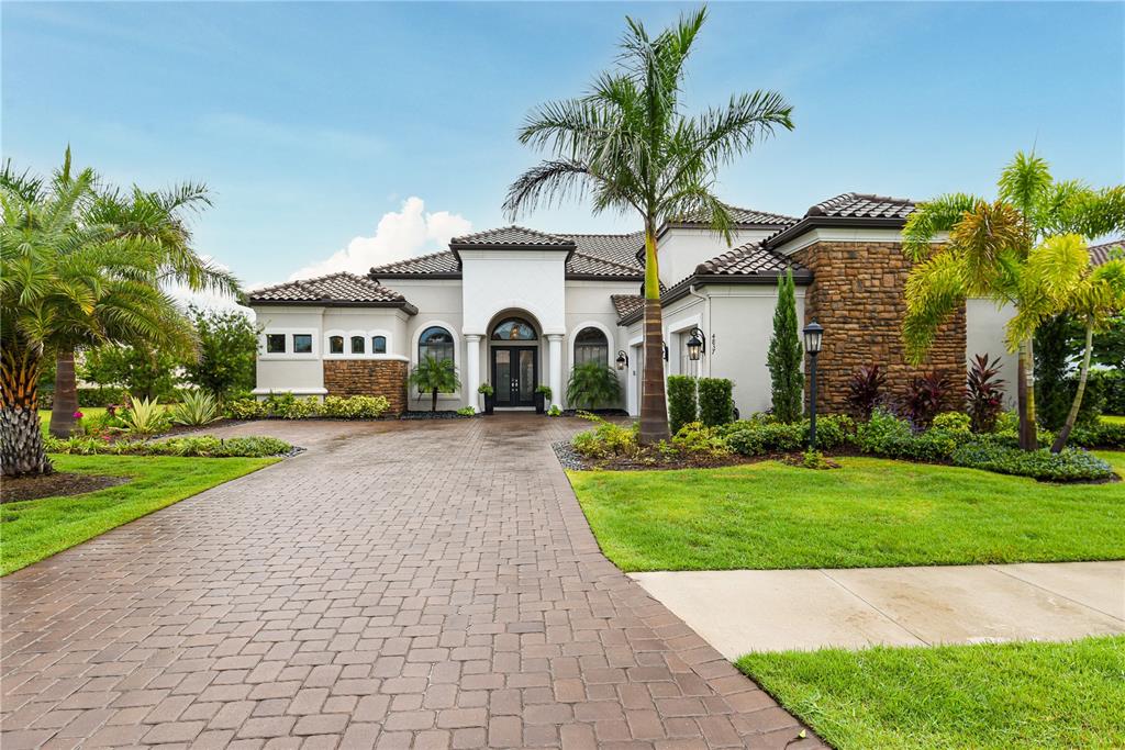 Exquisite luxury and coastal flair on one of the best golf course lots in Esplanade! Welcome home to this beautifully designed estate home with 4 Bedrooms, 4 Full and 2 Half Baths, an office/study, formal dining room, spacious family room, open concept living spaces and upstairs flex space. The double door with wrought iron detail opens to an entertainer’s dream home, with wood-look tile floors throughout, soaring ceilings with double tray and crown details, elegant upgraded light fixtures, and views to the outdoor living spaces that overlook the 7th hole of the Golf Course and the preserve beyond. The kitchen is the heart of the home, with custom cabinets with lighted upper displays, a massive quartz island with touchless faucet, farm sink, and counter height seating for 4. Enjoy meal prep with top-of-the-line stainless appliances including a wine fridge and vent hood. The office/study features double French doors for privacy. The massive living room is both elegant and relaxed, with a cozy fireplace surrounded by built ins. The Master Suite is a sanctuary, with custom walk-in closets, views of the pool and lanai, and a dream bath with a massive walk-in shower with custom tile treatment. The secondary bedrooms are spacious and have en-suite baths, and upstairs is a huge flex space with wet bar. Pocketing sliders bring the outside in, for the ultimate in Florida living. The spacious travertine lanai and pool deck surrounds a sparkling heated pool and spa with fountains and nebular lighting. The outdoor kitchen is fully equipped, including a cozy fireplace for chilly evenings poolside. Esplanade Golf & Country Club at Lakewood Ranch is a premier community with resort-style amenities, including Golf, tennis, pickleball, bocce ball, two amenity centers, fitness centers, resistance and lap pools, a resort style pool with Bahama Bar and Culinary Center. This is a GOLF membership home. Lakewood Ranch is the number one Master Planned community in the US and is conveniently situated between Sarasota and Tampa, with easy access to I-75, SRQ International Airport, world-class shopping, dining, and medical facilities, and just minutes to fabulous Gulf Beaches. Room Feature: Linen Closet In Bath (Primary Bedroom).