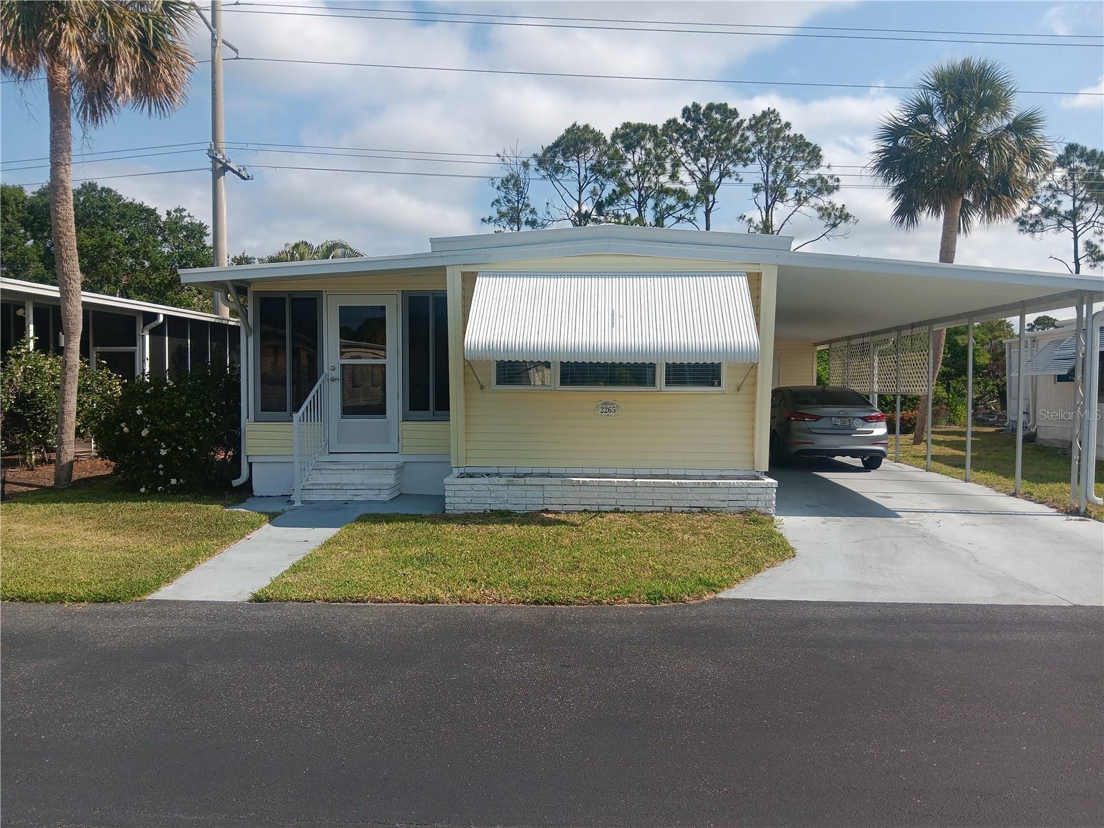 CUTE!! COZY!! CUMFY!! Here is your perfect, affordable, winter get-away or year-round home on Florida’s sun coast. This well-maintained and upgraded 2-bedroom, 1-bath home boasts a living area of 726 square feet including the lanai. Wood-grain laminate flooring AND it’s in one of Florida’s most sought-after 55+ mobile home parks, Venetian Estates. ARE YOU READY? NEW A/C Dec. 2024. NEW Moisture barrier 2024. BUT WAIT….THERE'S MORE: NEW..NEW...NEW ROOF Dec. 2024. This is the Best Deal In Town !!! Your very low monthly $175 HOA dues get you: lawn care + basic cable + garbage pickup+ WATER and SEWER service. Better call now before the bidding war gets underway! ! ! THE COMMUNITY: Large clubhouse next to the huge pool and hot tub. Parties, social activities, ice cream socials, bingo, trivia, and much more. It’s professionally managed. THE BIG FINISH: The home comes to you completely furnished, ready for you to move right in. It’s the best buy in a great park at a very-affordable price. Snowbirds love it. Year-rounders love it. AND YOU WILL LOVE IT TOO !!!