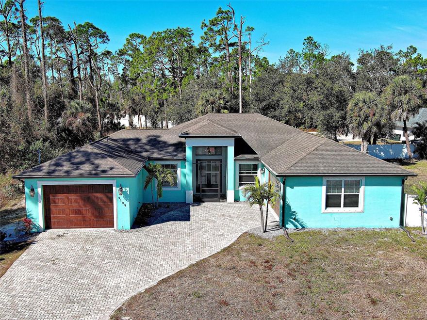 Welcome to this 2018 custom-built home located in the ever-growing City of North Port!  This stunning residence offers 4 bedrooms, 3 full bathrooms, and 2,337 square feet on an expansive 0.47-acre lot, creating the perfect setting for comfortable living, entertaining, and embracing the Florida lifestyle.  A paver driveway and paver entryway enhance the home’s curb appeal and welcoming first impression. The open-concept design connects the great room, dining area and kitchen.  Upon entry, the den offers flexible options such as a home office, study, or gym.  Stone countertops, stainless steel appliances, an oversized island, along with a built-in buffet and additional storage complete this chef-inspired kitchen.  The primary suite serves as a retreat, featuring sliding glass doors leading to the lanai, a walk-in closet, an ensuite bathroom with dual vanities, a walk-in shower, and a relaxing soaking tub. Two generously sized guest bedrooms provide abundant natural light and ample storage.  This home includes a separate in-law suite, ideal for multigenerational living or hosting extended guests. This private space features a living room, kitchenette, bedroom, bathroom, private patio access, and its own attached garage, offering comfort and independence.  Step outside to your oasis, highlighted by a Stonescapes heated saltwater pool with a mosaic mermaid design and a 6-jet spa. Entertaining is effortless with the outdoor kitchen, while the fully screened lanai provides the perfect setting to relax and enjoy peaceful yard views. Additional features include a vinyl-fenced yard and storage shed for added convenience.  Ideally located minutes from the future Sarasota Memorial Hospital, shopping, dining, and I-75, this home offers convenient access to Gulf beaches approximately 25 miles away and within one hour from Sarasota and Fort Myers airports. Schedule your private showing today!