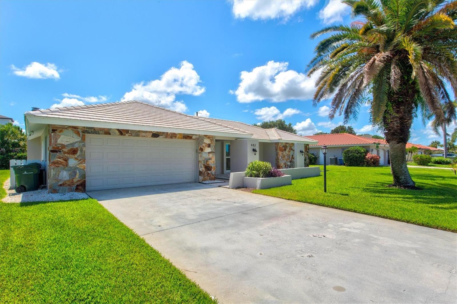 Nestled in the highly desirable Sorrento East neighborhood, this beautifully updated 3-bedroom, 2-bathroom home offers nearly 1,800 square feet of stylish living with a split floor plan, vaulted ceilings, and brand-new wood-look tile throughout. The bright, open layout includes a spacious living and dining area, a modern kitchen with wood cabinetry, granite countertops and high-end appliances plus two renovated bathrooms featuring shaker cabinetry and quartz countertops! The primary suite boasts an en-suite bath and cedar-lined closets, while hurricane-impact windows and sliding glass doors provide added safety. Step outside to a private backyard oasis with a sparkling inground pool, lush mature landscaping, fresh shell accents, and a covered lanai with a tongue-and-groove wood ceiling—perfect for outdoor entertaining! Just minutes from top-rated schools, shopping, dining, and only 4 miles to Nokomis Beach, this move-in-ready home blends comfort, style, and convenience!