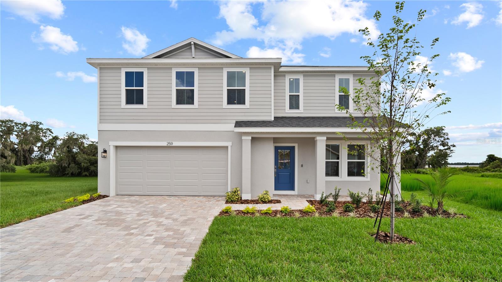 This stunning Highbourne with Coastal elevation greets you with a charming front porch, perfect for relaxing and enjoying the outdoors. Inside, a versatile flex space offers an ideal area for a formal living room or home office, conveniently connected to the kitchen. Just past the flex room is a thoughtfully placed half bathroom. The heart of the home features an expansive open-concept kitchen, dining, and living area, perfect for entertaining family and friends. The kitchen showcases elegant granite countertops, shaker cabinets, and a spacious layout. Sliding doors off the dining area lead to a covered lanai and an oversized backyard, providing serene views of the woods and lake. Upstairs, the oversized primary suite offers a luxurious primary bathroom with dual vanities, providing a private retreat. Three additional bedrooms and a centrally located laundry room complete the second floor, making the home ideal for families. The first floor is fully tiled, adding a sleek and easy-to-maintain finish throughout the main living areas. This Highbourne quick move-in home at Willowbrook North combines modern design, thoughtful layout, and beautiful natural surroundings, offering the perfect balance of comfort and style.