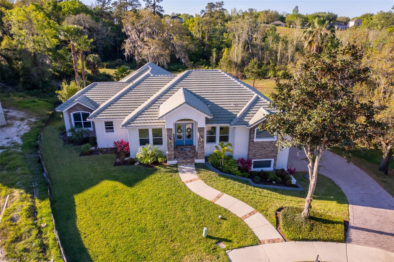 Exquisite 6-Bedroom, 4-Bath Estate in Sanctuary Golf Estates, Apopka, FL
Step into luxury and comfort in this remarkable estate home nestled within the secure, gated community of Sanctuary Golf Estates. Set on a generous 1/3-acre lot at the end of a quiet cul-de-sac, this property boasts breathtaking views of preserved conservation lands and offers an unparalleled lifestyle for discerning buyers.
Key Features:
Spacious and Versatile Layout:
Main Floor: Enjoy an open-concept design featuring 4 beautifully appointed bedrooms and 3 elegantly designed bathrooms. The spacious kitchen, complete with a cozy breakfast nook, is perfect for both family meals and entertaining, enhanced by abundant natural light and serene outdoor views.
Homeowner Extended Downstairs Basement: This fully finished area has been thoughtfully added by the homeowner and includes an additional 2 bedrooms, 1 full bathroom, a comfortable living room, a formal dining room, and a quaint kitchenette equipped with a sink and refrigerator—ideal for guest accommodation or in-law quarters.
Outdoor Living & Entertaining:
Escape to your private oasis featuring a sparkling pool and spa set against a backdrop of lush, natural scenery. Enjoy the gentle breeze and beautiful sunsets from the screened-in lanai, highlighted by an elegant wood ceiling.
Prime Location & Tranquil Setting:
Located in the heart of Apopka, FL, within the highly sought-after gated community of Sanctuary Golf Estates, this estate offers a peaceful retreat with the convenience of nearby amenities. The home’s position on a cul-de-sac enhances privacy and tranquility while providing stunning views of nearby conservation lands.
This estate home is a rare find—a perfect blend of modern conveniences and expansive, serene outdoor living spaces, ensuring comfort, privacy, and a timeless appeal. Don’t miss the opportunity to make this luxurious property your new home.