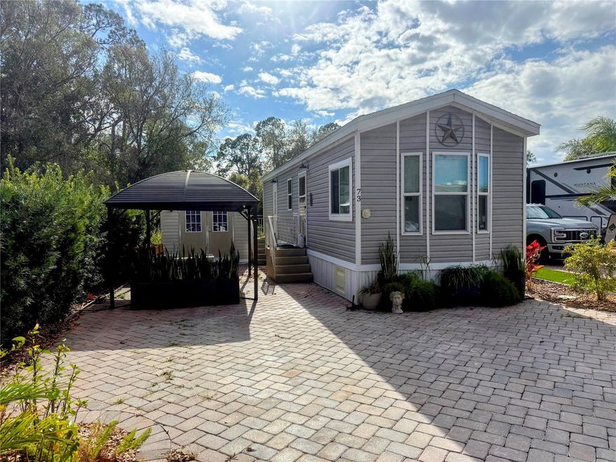 Welcome to Citrus Valley RV Resort in Clermont, Florida—where resort-style living meets flexibility and opportunity. This land-owned, non-age-restricted property features a 2022 Chariot Eagle home and is believed to be the only true two-bedroom home in the community, making it a rare offering.

Situated on a premium lot backing to a pond and protected wildlife nature preserve, the property offers peaceful views and exceptional privacy. The 492 sq ft home features an open floor plan, vinyl flooring throughout, standard ceiling height, pocket doors, and a well-appointed kitchen with refrigerator and microwave. The bathroom includes a walk-in shower and tub combination. Central air conditioning with a heat pump provides year-round comfort.

The home is being sold fully furnished, including televisions, allowing for immediate use as a primary residence, second home, or short- or long-term rental with no known minimum stay requirements.

Outdoor features include mature banana, lemon, and lime trees, aloe, and ample space for gardening. A custom drip irrigation system installed in 2025 services the entire property with the ability to isolate or remove individual zones.

Additional improvements include a gazebo and a shed converted into a studio or office, equipped with a 2025 mini-split heating and cooling system. Temporary power has been supplied, and space has already been provided for the future installation of a dedicated electrical subpanel.

The community allows screen porch or sunroom enclosures, offering the potential to nearly double the living space by removing the gazebo and repositioning the shed, subject to park guidelines.

Residents enjoy a gated community with resort-style heated pool, clubhouse, and fitness center. The COA fee is quarterly which includes water, sewer, internet and cable, trash service at common areas, and common area maintenance. Electric service is provided by SECO Energy.

Conveniently located within one block of Publix, between Four Corners and downtown Clermont, just 5 miles from Lake Louisa State Park, and only minutes from Walt Disney World, this property offers exceptional lifestyle and investment potential.