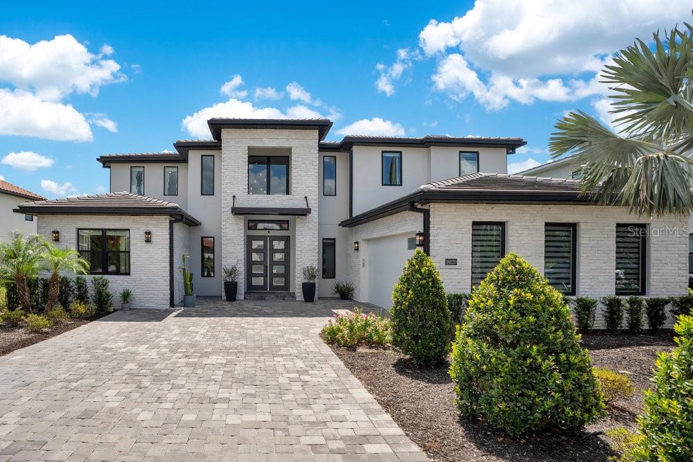 Don’t want to wait for a new build or go through the hassle of endless decisions? Looking for a move-in ready, lakefront home with all the modern upgrades ? This is the perfect opportunity for you! This stunning 5-bedroom home on Lake Siena is ready and waiting. Enjoy breathtaking water views from nearly every room, with an open-concept floor plan that blends elegance, comfort, and functionality. A gourmet kitchen with an oversized island, top-of-the-line KitchenAid appliances, a 6-burner gas range with griddle, triple ovens, and ample cabinetry. A glass-enclosed wine room adds elegance, while the great room boasts an accent slatted wall with a hidden door that leads straight to the 1st-floor primary suite, giving you quick access and total privacy. The primary suite offers a spa-like experience with a freestanding soaking tub, a large walk-in shower with a rain head, double vanities, a separate makeup vanity, and double walk-in closets. An additional en-suite bedroom was added on the first floor, along with a private home office.
Upstairs there are three additional bedrooms, a loft, and a massive BONUS ROOM ready to be transformed in a game room, home theater or the gym of your dreams .Two bedrooms share a Jack-and-Jill bathroom with separate vanities, while the third bedroom includes an en-suite bath. So many beautiful and modern design details are found throughout, including decorative tile in the 1st-floor powder room and laundry room. The laundry room is enhanced with custom pedestals for the washer and dryer, added cabinetry, and a laundry tub. This home also offers a 7-camera home security system, ample garage storage with ceiling-mounted safe racks, wall-mounted cabinets, and epoxy flooring.
This home's backyard has been specially built with a beautiful and modern pool, and so much outdoor space perfect for entertaining family and friends while enjoying the BEST of Florida Nature ... the Sunrises, the sunsets are truly amazing and yes you can enjoy —Disney fireworks too! This home has everything you've ever dreamed of... Bella Collina is one of Orlando's most charming golf communities, known for its impressive clubhouse offering panoramic lake views, a championship golf course, har- tru tennis courts, fitness center, resort style pool and luxury homes. Inspired by Tuscan style, it offers a unique and private environment, only 30 minutes from Disney. Detail Video: https://listing.trevisuality.com/vd/207935966 3D Video:https://listing.trevisuality.com/vd/207937381
