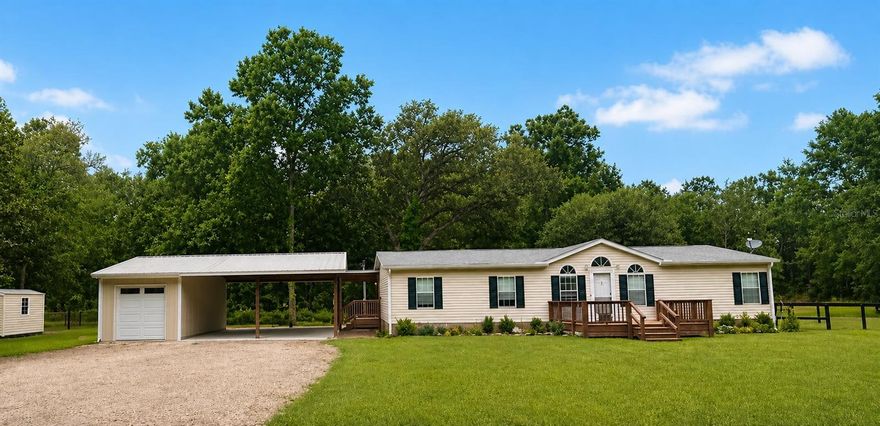 Motivated Seller! Welcome to a 5-acre mini farm in Horse Capital of the World! This bright 3-bedroom, 2-bath home features a split floor plan, spacious living room with a dedicated work area, and a large primary suite with walk-in closet and updated bath. The sunny eat-in kitchen offers plenty of cabinet space and opens to a charming deck—perfect for outdoor dining. Enjoy two decks, a large indoor laundry room, and direct access to a beautiful pole barn with two parking spaces (easily converted to stalls) and storage. The fully fenced property includes a paddock, dog yard, and room to expand, with shade trees surrounding lush pasture. Ideally located just 5 minutes from HITS and 15 minutes from World Equestrian Center, this home is close to shopping, dining, and medical. Updates include luxury vinyl flooring, new roof (2021), well pump (2021), water softener, and pole barn (2022). Perfect for enjoying Florida’s outdoor lifestyle year-round!