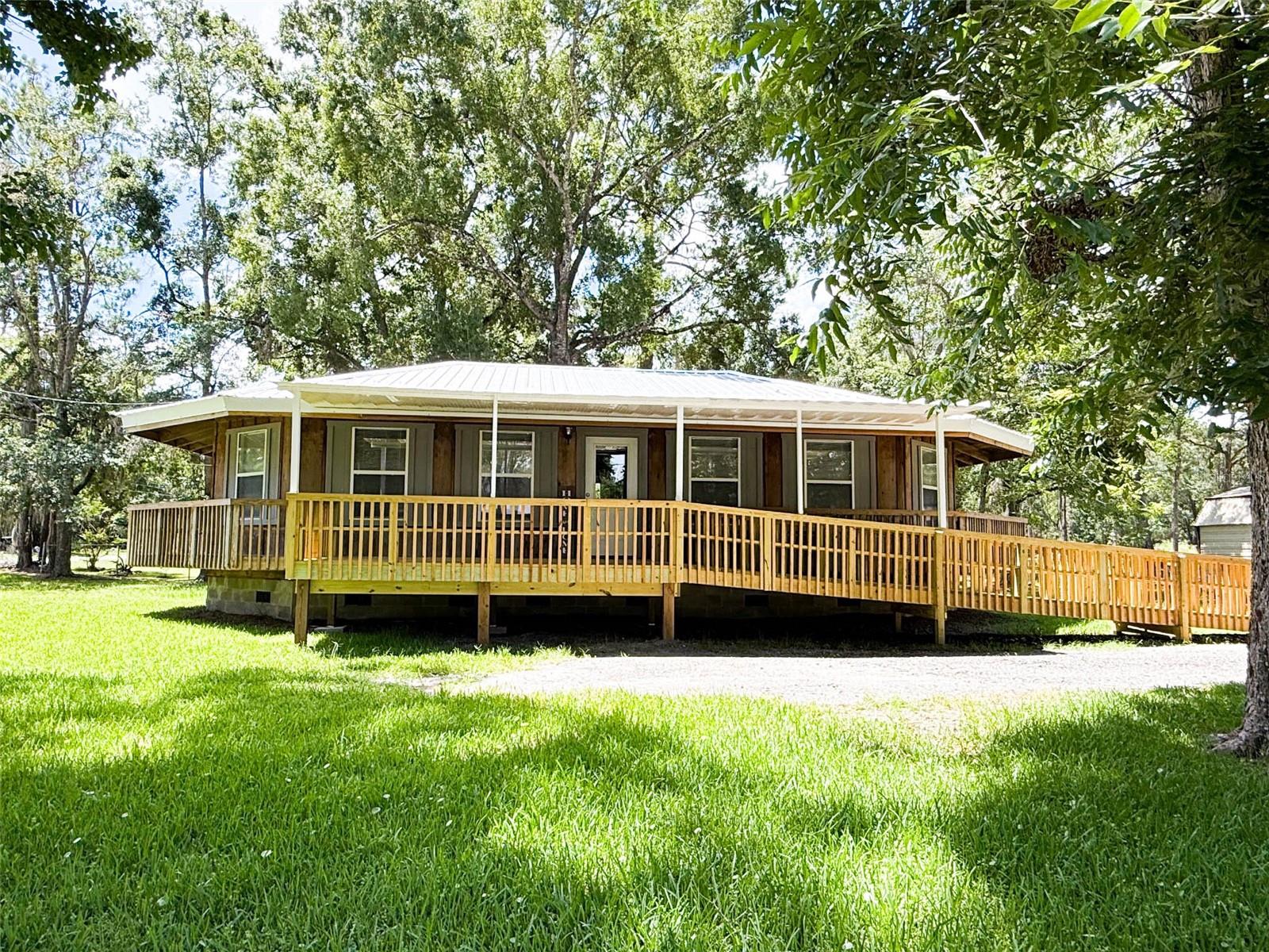 Discover this unique 3-bedroom, 2-bath home in Starke, Florida — a true standout with its all-wood construction inside and out! Featuring 1,216 sq. ft. of living space, the open-concept design seamlessly blends the remodeled kitchen and living room, creating a warm, inviting atmosphere. Enjoy the charm of the wrap-around porch, perfect for relaxing or entertaining. The property also offers a 10x12 metal storage shed and convenient access ramp. In addition the roof was replaced in March 2022. A rare find with character, ready to welcome you home! Easy commute to Gainesville and Jacksonville.