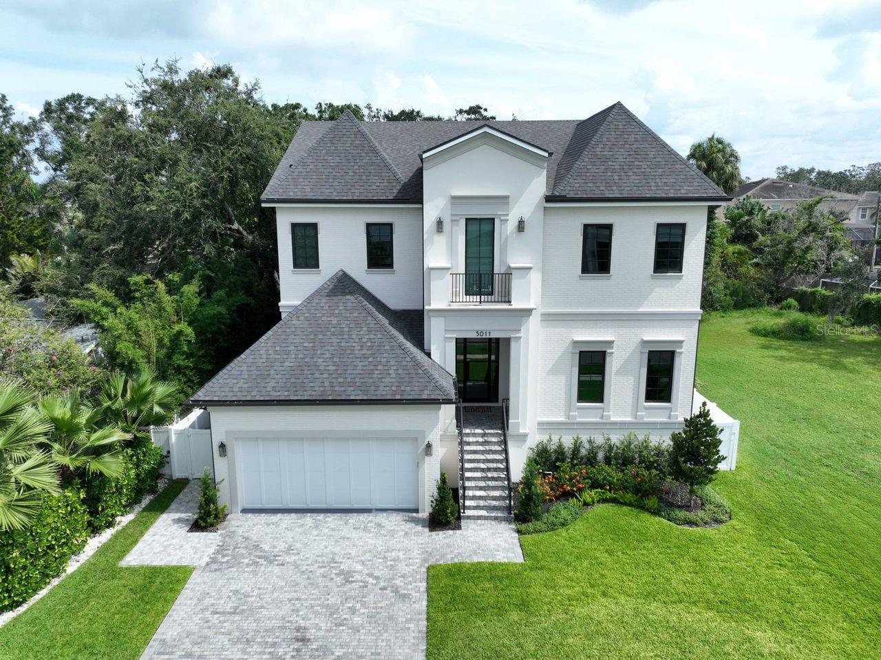 Welcome home to this newer construction South Tampa Sunset Park home. The Milana Custom home is thoughtfully designed and includes 5 large bedrooms, 5 full bathrooms, and a half bath leading to the lanai/pool area. This is a wonderful family home with great entertaining spaces. The first floor includes an open-floor plan with a grand foyer, bedroom, mud room, dining room, family room with a gas fireplace, gourmet kitchen, huge pantry with plenty of storage space and a two car garage with plenty of storage space. The back yard includes a pool/spa, putting green, large back yard for kids or pets, outdoor kitchen, large entertaining area, a huge remote controlled sunshade, and a half bath. Take the grand stairs up to the second floor and you will find the master suite with two large walk-in closets and a luxurious ensuite bathroom with plenty of storage and space. There are also three additional bedrooms with ensuite baths and walk-in closets. The laundry room and a large loft complete the second floor. This home is located in the highly desirable Sunset Park neighborhood and is close to Tampa International Airport, shopping, dining, and a top-rated school district. Schedule your private showing today.