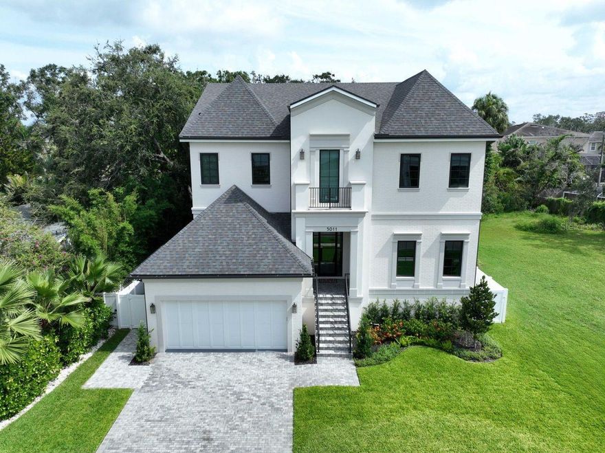 Welcome to your dream home in the heart of South Tampa! This stunning two-story Sunset Park 2024 construction offers luxurious living with modern elegance and thoughtful design throughout. This Milana Custom Home is thoughtfully designed and includes 5 spacious bedrooms, 5 full bathrooms, and 1 half baths, this home is perfect for families and entertaining. This modern smart home features a full Google Home system including an integrated camera system, video doorbell, two Nest thermostats and smart garage door, Culligan water softener and three reverse osmosis water filtration points—offering advanced comfort, security, and water quality throughout. Step inside through the grand foyer, where you’ll be greeted by an open and airy floor plan. The first floor features a versatile guest suite, a convenient mudroom, and a tech room, perfect for working from home. The expansive great room seamlessly connects to the gourmet kitchen, which includes a large pantry with plenty of storage, state-of-the-art appliances, and plenty of counter space for culinary adventures. Step outside to your private oasis ideal for year-round outdoor living and entertaining. The expansive covered lanai with remote controlled roll down sunshade and outdoor kitchen overlooks a sparkling pool and large backyard perfect for kids and pets. The backyard also has a sizable 4 hole putting green. Upstairs, the master suite is a true retreat, featuring two generous walk-in closets and a luxurious ensuite bath with all the amenities you could desire. Three additional bedrooms, each with their own walk-in closets and ensuite baths, provide comfort and privacy for family and guests. A spacious loft and a convenient laundry room complete the second floor. The home also includes a 2-car garage, providing ample storage and convenience. This home is located in the highly desirable Sunset Park neighborhood and is close to Tampa International Airport, International Mall, dining and a top-rated school district.  Schedule your private showing today.