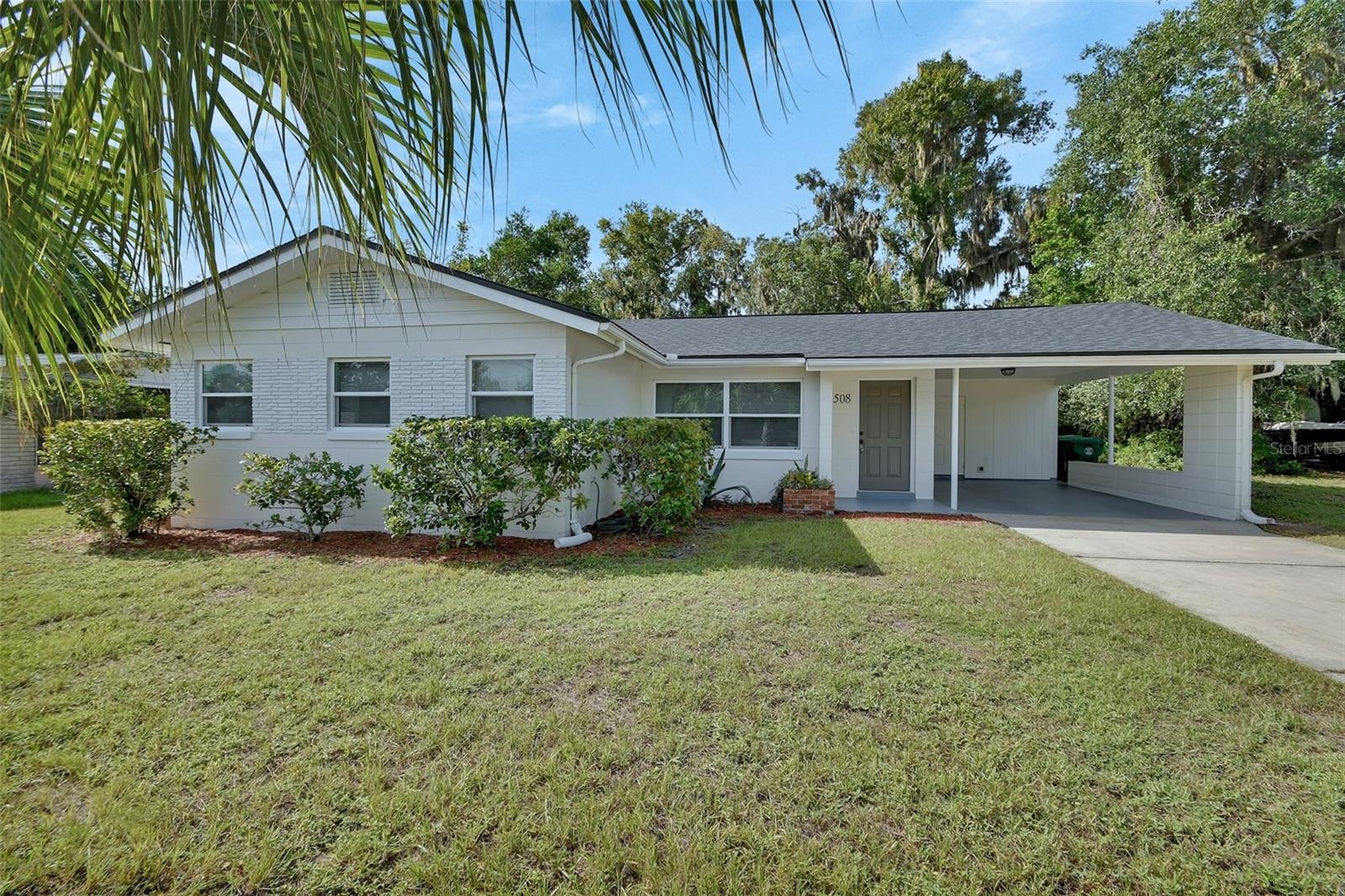 Discover the charm of this beautifully updated 1950s Mid-Century Modern home in the heart of Downtown DeLand! Featuring classic terrazzo floors that are gleaming with timeless elegance, this inviting home offers THREE spacious bedrooms and TWO FULL baths, complete with a convenient one-car carport.
From the moment you enter, you'll feel a sense of tranquility, enhanced by thoughtful updates throughout. A spacious storage and laundry room off the carport adds functionality to your daily living. Nestled on a high, dry lot, you're just a short stroll away from the vibrant downtown area and Stetson University.
Enjoy peace of mind with a brand-new roof (2025) and energy-efficient double-pane windows. This home is move-in ready—perfect for those seeking a blend of modern comfort and classic style!