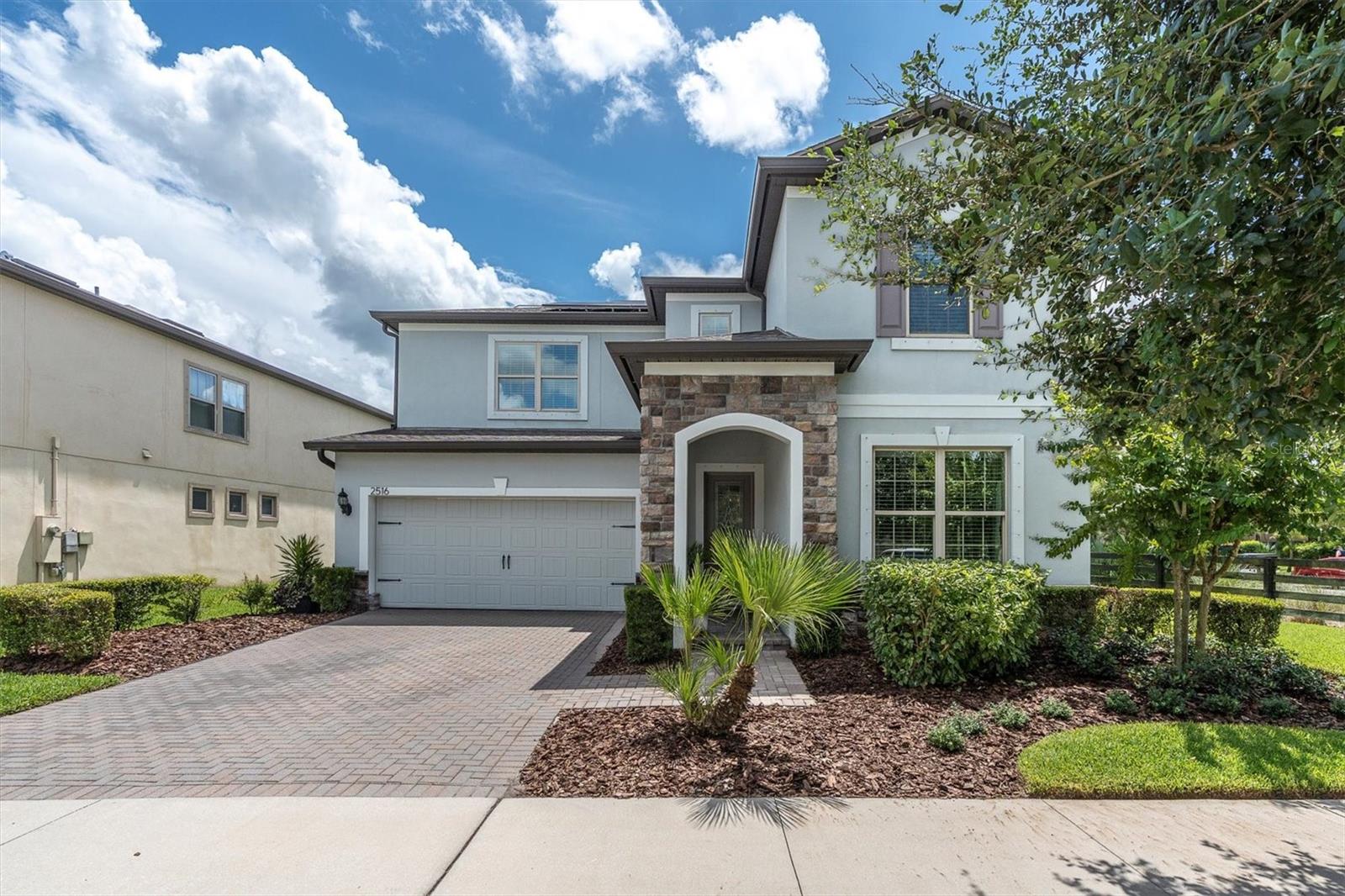 LUXURIOUS POOL HOME IN DESIRABLE STARKEY RANCH. Welcome to this magnificent luxury home nestled in exclusive Starkey Ranch, a true gem showcasing unparalleled elegance & sophistication. This exquisite PULTE VALLEYBROOK residence, custom-built in 2018, boasts a sprawling 5-br, 3.5-ba layout with loft + 2-car garage w/ extra storage, meticulously designed w/ over $150K in sophisticated upgrades, including SOLAR PANELS, situated on as oversized corner lot with privacy fencing and natural green barrier offering breathtaking east-facing views of sunrise over the pool. The extended Shellock paver lanai wrapping around the 14’x28’ saltwater pool with fully fenced yard is the perfect, private tropical oasis. The Craftsman-inspired exterior, with its 3 dimensional shingle roof, stone accents & shutters, pavers, & lush landscaping sets the tone for the luxury within. Entering the etched glass front door, be prepared to be captivated by impressive details like fresh interior paint, crown molding, board & batten chair rail and designer lighting. The warm-toned tile flooring flows seamlessly through the main living areas, complemented by 8-ft doors that enhance the sense of grandeur. To the right is BR 5 with French doors currently being used as a gym, a large closet and guest half bath. A dedicated formal dining room with board & batten, chandelier and tray ceiling with herringbone detail offers an inviting space to gather. The open floor plan unfolds into a living room where crown molding, a stylish chandelier, sliders with views of the pool & a custom built in stone accent wall with fireplace, mantel, shelves and cabinets create a sophisticated yet inviting space. Elegant gourmet kitchen is a chef's dream. White Shaker Wood Maple cabinets are complimented by matte black hardware & exquisite granite countertops and tile backsplash. Large island illuminated by pendant lights offer ample seating, while top-of-the-line appliances, including a Samsung refrigerator, Decorative Hood, Kitchen Aide 5-burner gas range, built-in stove + microwave, ensure culinary excellence. A casual dining café is framed in shiplap & anchored by chandelier. An extra office nook off the kitchen with built-in desk, large walk in pantry & custom drop zone offer additional organizing options. Ascend the stairs to the second story. A loft/bonus room is a multifunctional space. Retreat to the secluded Primary suite, a haven of tranquility featuring custom accent wall & ceiling fan. Indulge in the spa-like ensuite w/ dual vanities, cabinets, & walk-in shower w/ listello. Br 2 & 3 are connected by Jack & Jill Style bath 2. Well sized Br 4 offers adjacent full bath. Covered lanai featuring shellock pavers, is a sanctuary for relaxation & entertainment w/ sitting area, dining space, porch swing and a large saltwater pool. Fully Fenced backyard offers privacy and safety. Marvel at morning sunrises in your own backyard tropical oasis. *Garage Storage Racks* Reverse Osmosis & Water Softener*Gutters* Starkey Ranch offers an unparalleled lifestyle w/ its Magnet K-8 school, 3 community pools, playgrounds, dog parks & 20 miles of trails. Enjoy regular community events and easy access to shops, restaurants & Publix. Experience the grandeur in person and make this exquisite home yours.