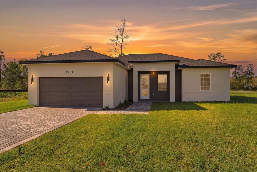 Welcome to this stunning newly built residence, perfectly positioned in one of Ocala’s fastest-growing areas. Situated on an expansive 0.34-acre lot, this home offers the ideal combination of privacy, modern living, and long-term value.

Thoughtfully designed with both style and functionality in mind, this 4-bedroom, 2-bathroom home features a bright and airy open-concept layout, enhanced by high ceilings and abundant natural light throughout.

The heart of the home is a true chef-inspired kitchen, showcasing a striking quartz waterfall island, premium wood cabinetry, full-height backsplash, and sleek stainless steel appliances — seamlessly flowing into the living and dining areas, perfect for entertaining and everyday living.

The spacious primary suite offers a private retreat, complete with a beautifully finished bathroom and generous storage. All bedrooms include high-quality built-in closets, providing both comfort and practicality.

Step outside through sliding glass doors to a large backyard with endless potential — ideal for creating your dream outdoor space, adding a pool, or simply enjoying the tranquility of nature.

Additional features include:
- Elegant brick façade for timeless curb appeal
- Professionally landscaped front yard
- Charming front porch
- Covered 2-car garage with automatic opener
- Dedicated laundry area
- Modern exterior LED lighting enhancing architecture and ambiance

This home includes a 1-year builder warranty, offering peace of mind and confidence in your investment.

Located in a rapidly appreciating area, this property is not only perfect for a primary residence but also presents a compelling opportunity for investors seeking growth and long-term returns.

Move-in ready and designed to impress — this is a rare opportunity you don’t want to miss. Schedule your private showing today.