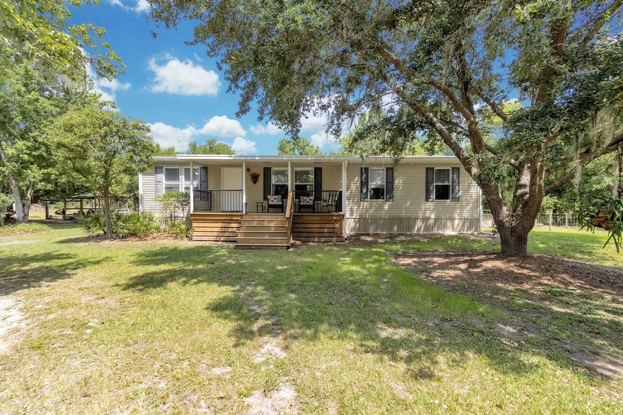 A PRIVATE POND + 2.83 ACRES + ROOM FOR ALL THE TOYS! After a long day, come home to peace and serenity on your own slice of country living—complete with a private pond, fishing pier, and views of cattle grazing beyond the fence line. Yes, this kind of property still exists! BEAUTIFUL, WARM AND COMFORTABLE LIVING! This meticulously maintained 4 bedroom, 2 bath home is immaculate, lives large, and SHOWS LIKE A MODEL. Step inside and you're greeted by a bright, airy living room with vaulted ceilings and crown molding, where natural light pours in and the space immediately feels open and welcoming—perfect for relaxing or gathering with friends and family. The PRIMARY SUITE is tucked to one side and features dual sinks with tall cabinetry, a walk-in shower, private water closet, a generous walk-in closet, and a high window that brings in natural light without sacrificing privacy. The split bedroom layout offers three additional bedrooms and a large full bath featuring dual sinks, tall cabinets and a tub/shower. The bright KITCHEN AND DINING COMBO with cohesive, stylish light fixtures offers a large island, abundant cabinet and counter space, stainless appliances, and a closet pantry—perfect for everything from holiday baking to everyday living. The kitchen flows seamlessly to the dining area with sliding glass doors, creating an easy connection to outdoor living. OUTDOOR LIFESTYLE - Start your mornings on the charming covered front porch overlooking the pond, and wind down in the evening on the screened back porch—perfect for outdoor dining or relaxing with a glass of wine while watching the neighbor's cows grazing or some of the Florida wildlife roaming about including wild turkeys and deer. The property is fully fenced with multiple gates, making it ideal for animals or simply enjoying the space. Outbuildings include a small pole barn for boat or equipment storage, a shed housing the water system (aeration and softener), and a small structure currently used for storage but is also suitable for goats, chickens, or other small animals. BRING THE BIG TOYS! There is plenty of room for a boat or RV, plus an RV hookup is already in place. UPDATES include a newer A/C (2021, under warranty) and well and septic replaced in 2015 (septic recently pumped). Tucked away in South St. Cloud, you get the best of both worlds—quiet country living just minutes from Publix, Walmart, and the Turnpike for an easy Orlando commute. So don't wait! SO DON’T WAIT! SCHEDULE YOUR SHOWING TODAY!