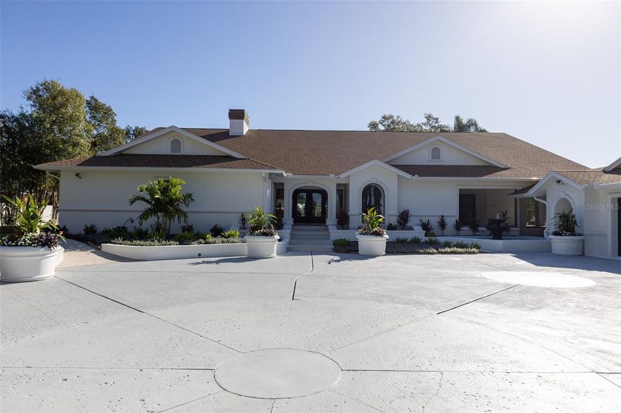 No flooding inside house during the hurricanes! Rare Water Front home on over 1 Acre. This is an entertainer’s delight with plenty of room for family and for everyone to feel special. Located within the Berkeley Preparatory School area and tucked away on a quiet street, this welcoming and gated home greets you with a spacious open layout perfect for entertaining. The foyer includes a large mirror for added light and a Restoration Hardware chandelier. At first glance, you see a beautiful stone fireplace, tall ceilings with recessed lighting, and all the way to the back, sliding doors, giving lots of light and a view of the water.  
 
Fully updated kitchen with new cabinets, quartz countertops, pot filler, and stainless-steel appliances. Soft close cabinets and walk-in hidden pantry with prep sink and more cabinets for extra storage. The kitchen has two areas for kitchen barstools, with one island and one peninsula. There are plenty of cabinets and drawers for storage and plenty of cooking prep room, perfect for large family gatherings.
 
Four en-suite bedrooms to the left on the main level all have walk-in closets and their own bathrooms. The laundry room on the main level boasts plenty of room for an extra refrigerator, cabinets for extra storage, and countertops for folding. 
 
The master bedroom suite has a sitting area, a large walk-in closet, a bathroom with a double vanity sink, a double shower with handheld shower head, rainfall shower head, and a soaking tub. The master suite also includes a private patio and storage closet on the right side of the house.  
 
Additionally, there is a private office upstairs with French doors and a large media/game room.  And a surprise room at the top of the spiral staircase for another office or more relaxing. This room has built-in bookcases and plenty more closets for storage space. 
 
The wonderfully entertaining outside area contains three very Zen-like patios to relax and unwind, along with two outside decks and a very large pool. Conveniently beside the pool is an outdoor pool house, which includes a half bath, grill, icemaker, and refrigerator, along with marine-grade cabinets and an island with seating area.  Taj Mahal upgraded countertops finish off the pool house area. 
 
Four plus car garage with another full bath and back room which could be used for bedroom or office. There is plenty of room for all your vehicles with extra storage space in the back, plenty of storage, and racks to store all your tools and/or seasonal décor.  
 
Other items: New Roof and New septic system installed in 2022 and barely used. New lighting, cabinets, and new sliding doors lead to the outside area. Four HVAC systems for the main house and one system for the garage room. New water heaters.  Outside termite monitoring system surrounds the house. New Key pad installed with electric gate at entrance.
 
This neighborhood is minutes from Tampa International Airport for easy access to travel, International Mall, Westshore mall, and plenty of restaurants and shops are within a short drive.