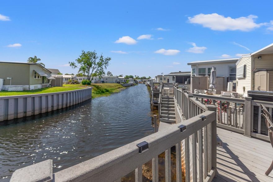 Always wanted to own water front home in Florida but thought it was just a dream?!?! It could be your reality. Pride of ownership shines through as you approach the home. The stunning driveway welcomes you to this beautiful home with front awning, patio and elevated covered balcony. This beautiful, well maintained 2 bedroom home is calling your name! Enjoy the tranquility of this canal location which leads to 175 acre Lake Davenport. This home boasts a good sized deck overlooking canal as well as screen room attached to the back of the home. This low maintenance home is packed with tasteful updates including laminate flooring in all but the bathrooms which are laminate vinyl. The kitchen has undergone some modification with new base cabinets, counter tops and decorating planks along the breakfast area. Lots of storage in the master bedroom, The second bedroom currently doubles as an office but has a futon which opens to provide sleeping accommodation for guests. This second bedroom has a half bath and laundry closet with full sized washer & dryer. The roof was replaced in 2024. This partially furnished home will suit the most discerning buyer. From the guard gated entrance to the clubhouse and amenities overlooking Lake Davenport, this community has something for everyone. tennis courts, two community pools, mini golf, etc. as well as different activities & social events for you to enjoy. Outdoor Resorts even has a beach with views of Lake Davenport. Time to enjoy the Florida lifestyle.