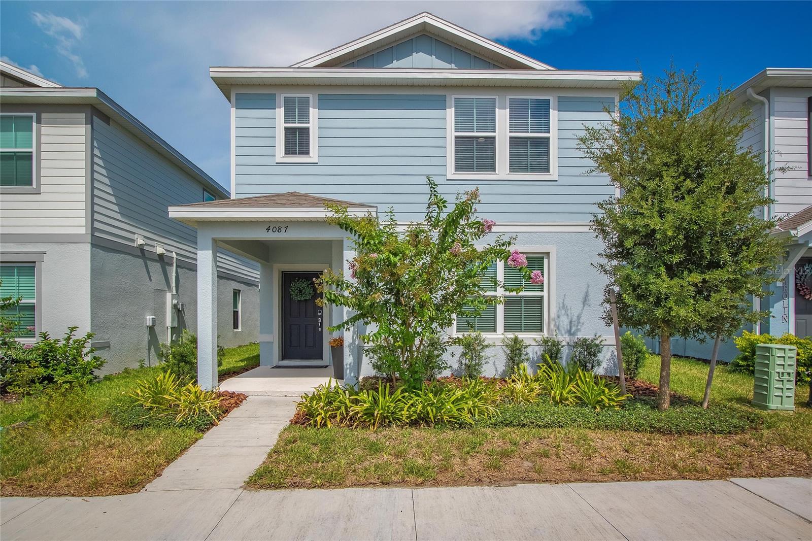 This 1-year-old home is light and bright and loaded with valuable aftermarket extras: a breezeway with a small yard, modern levolor window blinds, upgraded master glass shower door, home security with electronic locks and sensors, smart home features including wifi, wifi-enabled thermostat and garage control on an app, and a ring doorbell. This 4/3 Jasmine floor plan sold out quickly and includes a popular first-floor bedroom convenient for a home office or guest/flex room. Features an upgraded premier package including gray cabinetry, arabesque backsplash in kitchen, lagoon countertop in kitchen and bath, wall tile positano, 21x21 floor tile Positano, upgraded wall paint, and a tankless water heater. More seller upgrades include a large refrigerator with bottom freezer drawer, ceiling fans, and lights. Neighborhood pool, playground and walking trail.