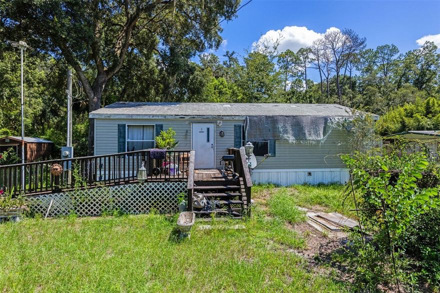 Experience quaint, rural living with a 2-bedroom, 2-bath 2013 manufactured home on a quiet 0.28-acre lot just outside Ocala National Forest. Storage shed and open layout for relaxing or entertaining. Large private yard—great for pets or gardening. Convenient access to trails, lakes, and outdoor adventures, all minutes from shopping and amenities. Good choice for first-time buyers, investors, snowbirds, or anyone seeking a serene getaway.