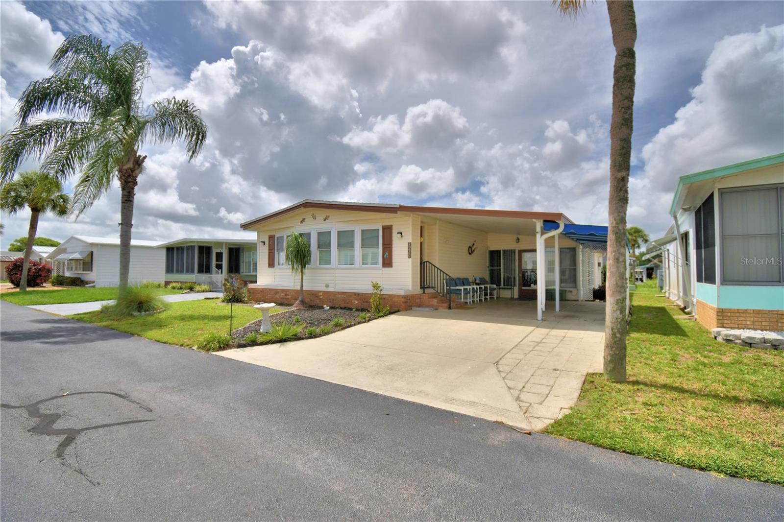 You won't want to miss this opportunity. This home comes furnished with what you see. As you walk into the front door you see the inviting Florida Room just perfect for your morning coffee. Passing through the Florida Room you find the spacious living room, perfect for entertaining, complete with drywall instead of paneling. They updated kitchen and dining area follows. The kitchen offers lots of space and cabinetry. The laminate flooring in the home is just a few years old. As you walk through the home you will find spacious bedrooms tastefully furnished. The side lanai offers additional space, perfect for entertaining. The shingled roof was installed in December 2019. Step off the driveway and walk across the street to the larger of the two pools offered in the community. This is the pool where water volleyball and water aerobics happen!! Oakwood Estates, a 55+ community offers many amenities such as shuffleboard, two pools and two clubhouses, miniature golf, bocci ball, tennis courts, and much more. You can be as busy as you want in this community, or you can sit back and enjoy the quiet and peaceful community. Make your appointment today!!