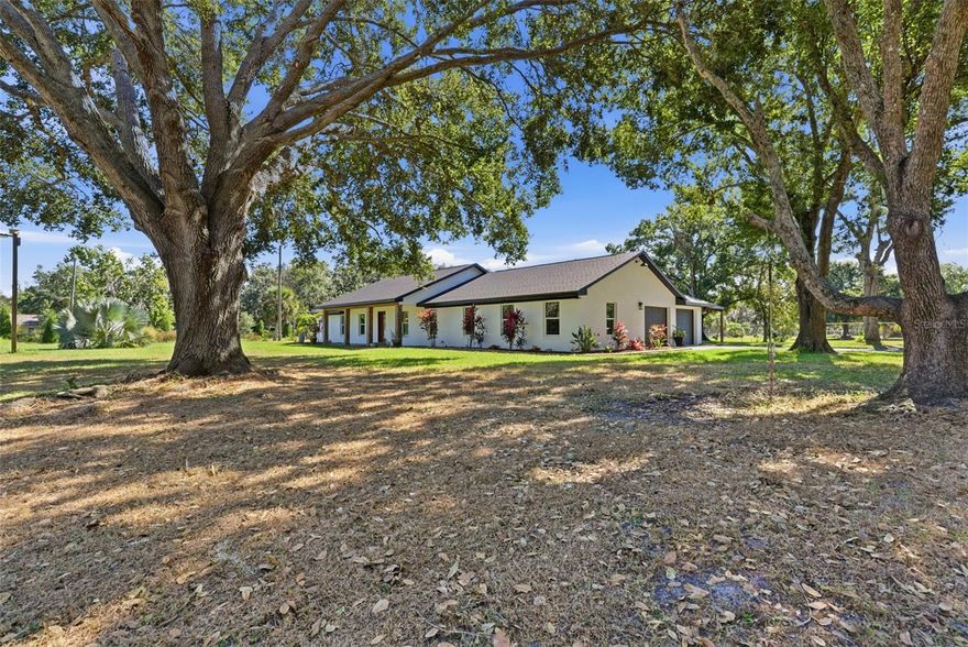Looking for privacy? This beautiful traditional home sits on 3.5+ acres, is gated, and features its own fully stocked pond and a barn/storage building. Inside features 3 beds, 3 baths, a 2-car garage, and an open formal living/dining area. Spacious kitchen opens to the large family room. with granite countertops, stainless steel appliances, and a copper sink. The Primary Suite features engineered wood floors, dual sinks, and a custom double shower. The 2nd bedroom has an en-suite bath being remodeled, and the 3rd bedroom connects to a Jack-and-Jill bath. Updates include A/C 2024, a new Septic tank in 2023, and a new roof in 2023. Windows and doors were replaced in 2016 and 2019.  Enjoy the covered patio with plenty of space for entertainment. Easy access to I-4, plenty of room for RV/boat parking. Schedule your showing at Hawks Griffin today!