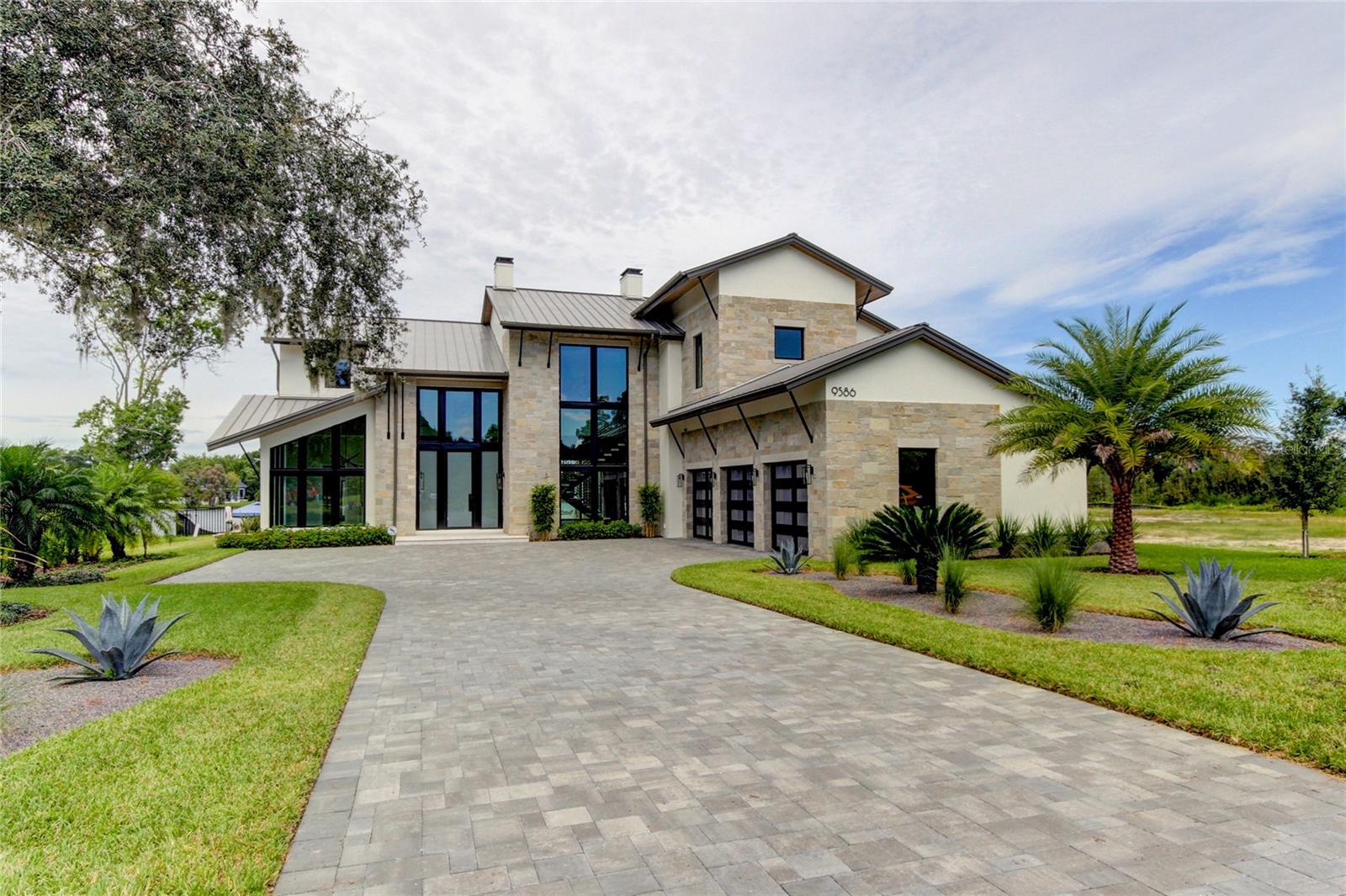 Introducing a Edgewater at White Trout Lake, in the middle of everything but once behind the gates, the beauty serenity of lakefront living. Situated in the heart of Tampa lies a private gated enclave with 9 luxury homes on very accommodating lots. Lot 5 is approximately 25,000 sq ft. This home has been the "show" home built by Alvarez Homes, builder of over 500 luxury custom homes. This home is a must see, absolutely beautiful in and out. Nothing has been overlooked. Energy efficient, certified green, Eco-friendly to provide the customer with the latest cost savings technology. The home will need to be leased back for a few months, perfect for those moving into the area and needing to know they have a home to come to.
The community is 20 minutes to TIA, 15-20 minutes to Tampa General, St Joseph Hospitals (North and MLK),Moffit and USF medical facilities. White Trout Lake is an 88 acre ski-sized lake and one of the more popular lakes in North Tampa.