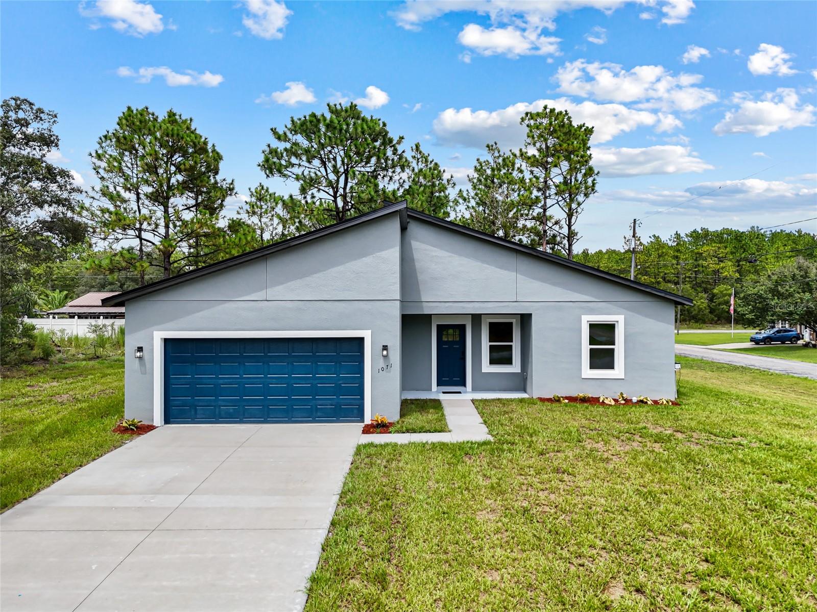 Brand New, modern, bright and spacious 4-bedroom, 2-bath home, perfectly positioned on a premium 0.3-acre corner lot for added privacy and extra outdoor space. From the moment you walk in, you’ll notice the elevated finishes, thoughtful design, and natural light that fills every room.
The open-concept layout features stylish slatted wood detailing in the living room and on the kitchen island, adding modern character. The kitchen is both beautiful and functional, with stainless steel appliances, a pantry closet for extra storage, and a central island that opens seamlessly to the dining and living areas—perfect for entertaining.
Your luxurious primary suite offers his-and-hers walk-in closets, a spa-inspired bathroom with dual sink, a walk-in shower with glass door, and a standalone soaking tub—your own private retreat.
Practical features abound, including a spacious two-car garage and a separate laundry room to keep daily life organized and clutter-free.
This property seats on a prime location, just minutes from the plaza with Target, ALDI, Hobby Lobby, and Texas Roadhouse, multiple golf courses, plus multiple state parks including Rainbow Springs and Hálpata Tastanaki Preserve. You’ll enjoy the perfect balance of convenience and outdoor adventure. And with **no HOA or CDD fees** plus a **full builder’s warranty**, you get peace of mind and the freedom to truly make this home your own.