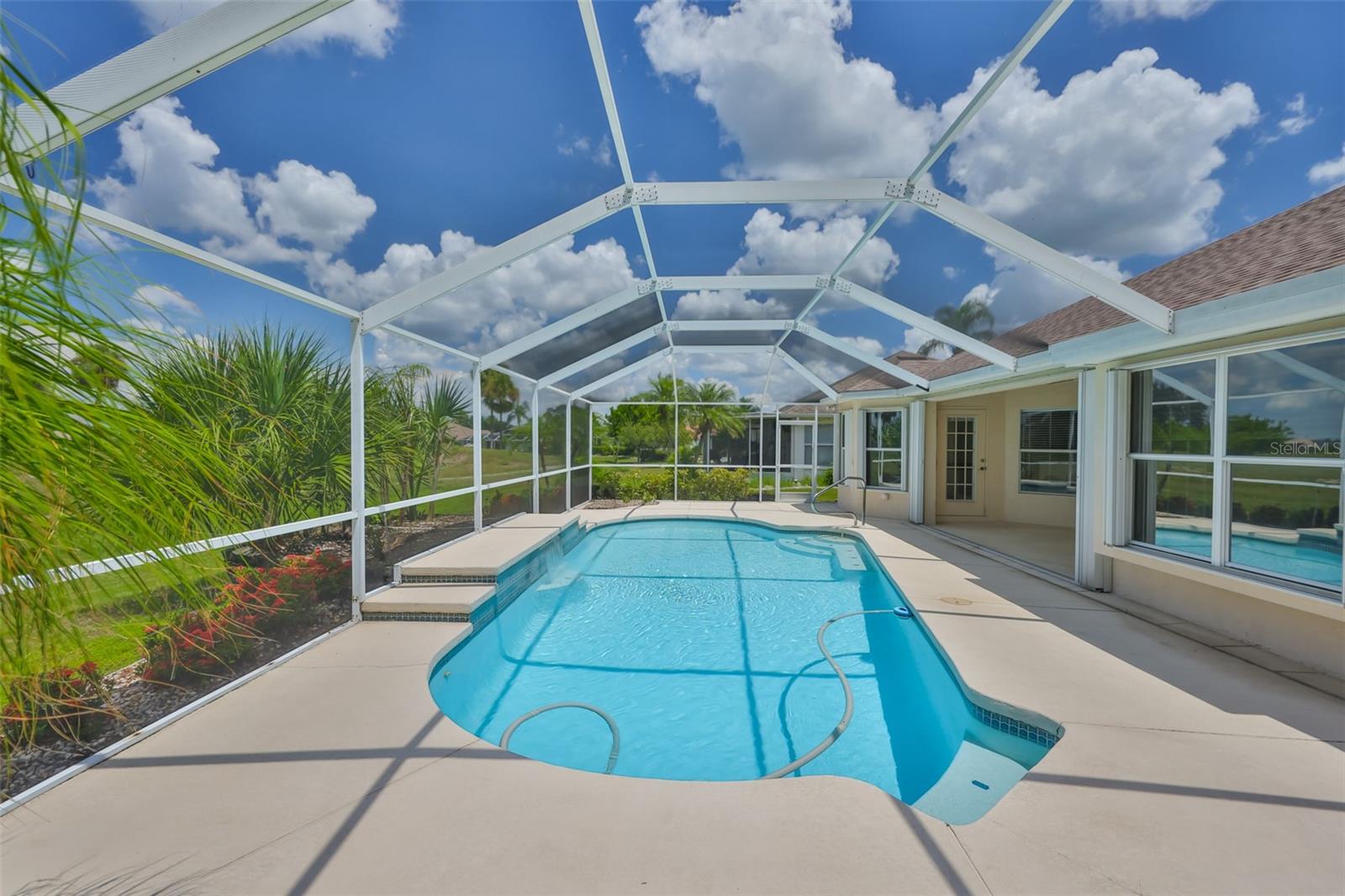 Wow! You really can have your own waterfall pool with an automatic cleaner and huge screened landscaped lanai with a roofed area, ceiling fan and an outdoor shower where you can watch the sunsets over the pond! Plenty of room for lounging, pool side eating and grilling, this pool/water-view home has it all! Privacy is assured with the conservation area in the rear of the home and the pond. 2 bedrooms plus office or den with a bay window, dining room with new chandelier, great room with vaulted ceiling, sliding doors to the pool and lanai and a new led ceiling fan. Kitchen has a pool/lanai door with built in blinds, closet pantry, stainless microwave, dishwasher and refrigerator, dual sinks, refrigerator, dual ceiling fans with lights, counters galore, reverse osmosis system, built-in desk and dinette with new lighting; bay window views of the pool and pond too! Check this out: screened front door area with stained glass above door and sidelight and a brand new Roof in 2025 with transferable warranty! This is a no worries home! Primary Suite with new led ceiling fan, window seat, water and pool view, pool/lanai door with built in blinds, walk-in closet with built-ins, bidet, dual sinks with new faucets, vanity with drawers, garden tub, a separate stall shower and glass block window for privacy! Den/study and second bedroom both have new led ceiling fans. Second bath has a tub/shower combo with glass sliding doors and a bidet, too. All appliances stay with the home. Separate laundry with cabinets and gray Maytag front loader washer and dryer. Garage has a workshop and plenty of racks for storage. Free irrigation by the association and they do the maintenance! Sun City Center has been rated the top value retirement community in the US. From entertainment to sports to hobbies and clubs, we have it all! Run, don't walk!