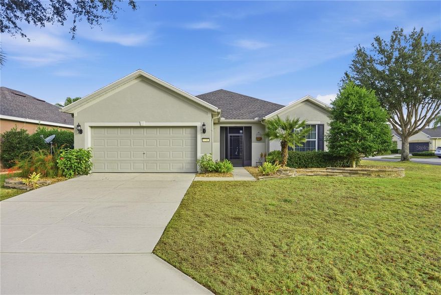 Situated along Sebastian Lake, this Stetson model offers tranquil water views and a beautiful fountain outlook, with the golf course located just across the lake in the Spruce Creek area of Ocala. The home features 2 bedrooms, 2 full baths, and a versatile flex room suited for an office, den, or hobby space. A screened porch opens to a fenced yard, creating a comfortable place to relax and enjoy the scenery. Interior highlights include granite countertops, luxury vinyl flooring, and stainless steel appliances, along with a two-car garage. The roof was replaced in 2022 and the AC system in 2021, giving added confidence in the home’s major systems while you enjoy its setting and easy-living layout.