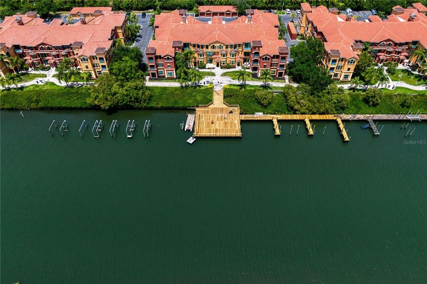 This exquisitely appointed 2,078-square-foot residence within the gated Grand Bellagio at Baywatch enclave embodies coastal-inspired living. The arrival experience is anchored by an attached two-car garage and a luminous main-level floor plan defined by a palette of light greige and arched transitions. Wood-look flooring laid in a meticulous herringbone pattern flows through the foyer, living, and dining areas, leading to a professional-grade culinary stage. For the epicurean, the kitchen features classic raised-panel wood cabinetry, slate-finish gas appliances, and an earthy-toned mineral backsplash that complements the clean, light-hued surfaces. The main floor is designed for effortless hosting, featuring a half-bath for guests and a seamless transition to the family sanctuary, where chevron-patterned hardwood floors and a stone-surround gas fireplace serve as the focal point.

The upper level features a private wellness wing housing all three bedrooms, ensuring absolute tranquility and separation from the social areas. This level includes a versatile second bedroom masterfully engineered with an integrated queen-size Murphy bed and a built-in executive workspace. The primary retreat is an expansive sanctuary featuring multiple large windows with alabaster-toned louvered shutters and a spa-inspired ensuite. This primary bath is perfectly balanced with a split vanity design, warm stone countertops, a large soaking tub, and a framed glass shower for an unparalleled wellness experience.

The lifestyle extends beyond the interior, offering an unparalleled maritime advantage, including a private BOAT SLIP. For the modern adventurer, the two-car garage has been upgraded with a professional flake epoxy floor, extensive silver-toned metal wall storage, and a heavy-duty ceiling-mounted rack system. Every detail, from the farmhouse-style lantern pendants to the artisanal cloud-toned plantation shutters, has been curated to deliver an elevated Florida lifestyle without concession. Strategically positioned within the Grand Bellagio community, residents benefit from a Mediterranean-inspired environment featuring a resort-style heated pool, clubhouse, 24-hour fitness center, sand volleyball court, tennis courts, playground, dog park, and car wash station. Woven into the scenic 1.5-mile waterfront jogging trail along Old Tampa Bay, this distinguished property delivers a high-performance residential experience.