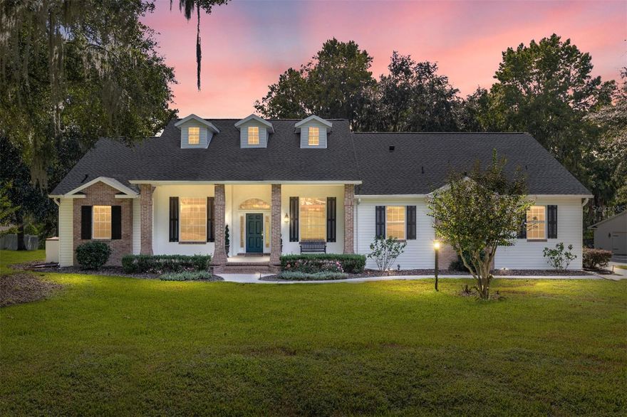 Tucked away in a beautiful, gated SE Ocala community, this four-bedroom, three-bathroom home sits on an oversized lot at the end of a quiet cul-de-sac. From the moment you arrive, the charming curb appeal, large front porch, and stately brick columns set the tone for the warmth and character found throughout. Step inside to soaring ceilings, rich wood floors, and spacious living areas filled with natural light. The heart of the home is a stunning kitchen featuring abundant cabinetry, a beautiful brick backsplash, and a gas-burning fireplace that creates a cozy, inviting atmosphere. Whether you’re hosting family gatherings or enjoying a quiet evening at home, this space truly impresses. Designed for both comfort and flexibility, the layout includes two guest bedrooms that share a full bath, while a third guest room- currently serving as a home office- enjoys the convenience of a separate full bath. The oversized screened-in porch provides the perfect place to unwind and take in views of the expansive backyard — complete with a playset, fire pit, and plenty of room to roam. A detached two-car garage adds versatility for a workshop, hobbies, and all of your recreational toys. Located just minutes from Ocala’s vibrant downtown, shopping, restaurants, and medical facilities, this home blends peaceful living with everyday convenience. With its thoughtful design, exceptional setting, and timeless style, this property is one you’ll be proud to call home.