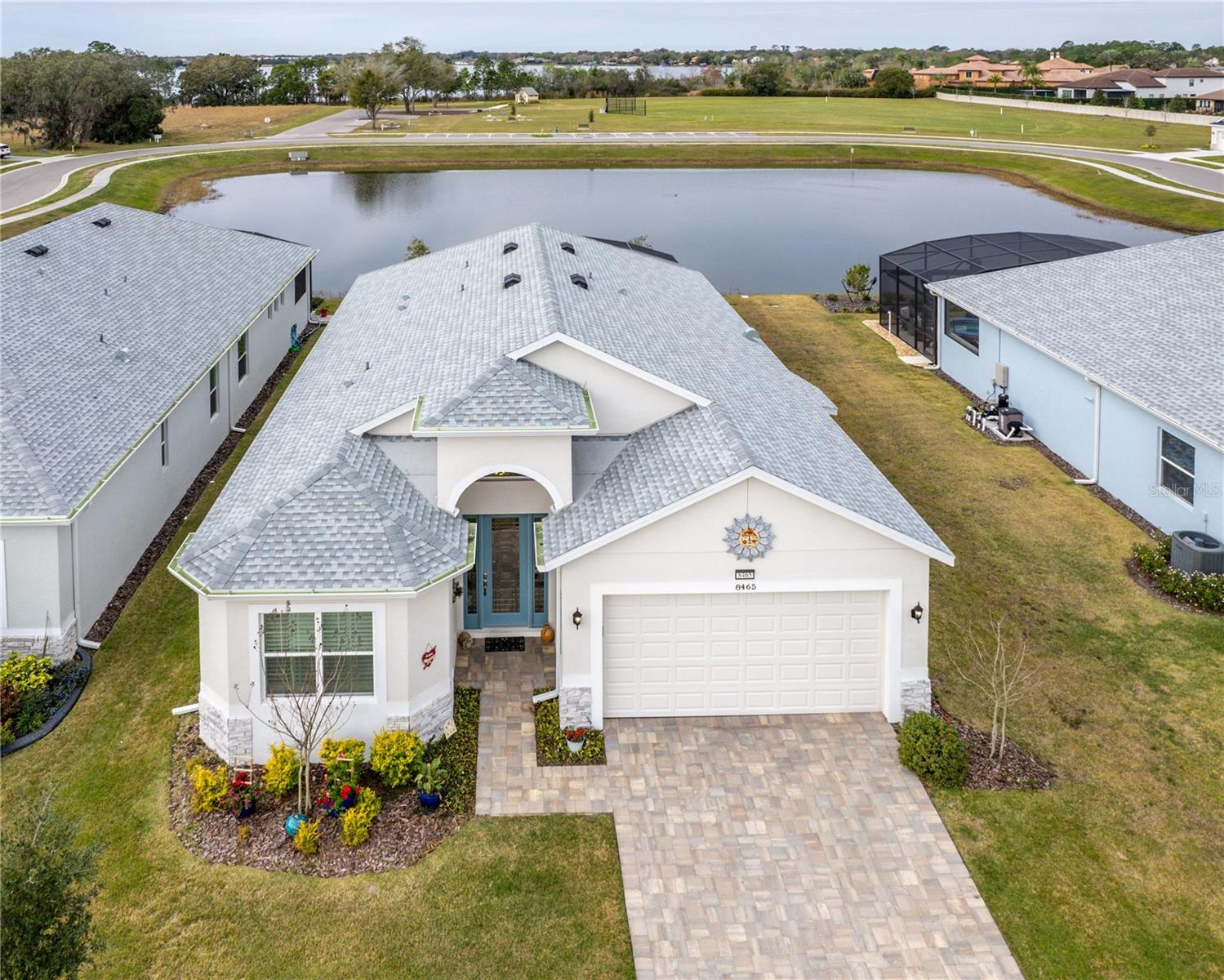 Nestled within the desirable and award-winning 55 plus community of central Florida, this stunning residence embodies the pinnacle of luxury living for discerning adults. Boasting impeccable design and unparalleled amenities, this home offers a lifestyle of sophistication and comfort. The open floor plan home features 3 bedrooms and 2 baths with one bedroom set up as a den with no closet. Bedrooms feature luxury vinyl flooring and upgraded lighting.
Upon entering, guests are greeted by a detailed entryway that sets the tone for the elegance found throughout the home. High ceilings and gorgeous porcelain tiles laid on the diagonal create a sense of grandeur, while a tray ceiling in the living room adds an extra layer of refinement. The electric fireplace not only adds warmth but also creates a cozy ambiance, perfect for relaxing evenings.
The living room seamlessly transitions to the outdoors, offering water views and allowing residents to enjoy the natural beauty of the surroundings from the comfort of their home.
The gourmet kitchen is a chef's dream, featuring exquisite quartz countertops and modern appliances. An eat-in nook provides the ideal spot for casual dining or morning coffee.
Practicality meets luxury in the laundry room, complete with built-in storage and a convenient mud sink, making daily chores a breeze.
Experience the ultimate in luxury living in this exquisite home, where every detail has been thoughtfully designed to elevate your lifestyle.
The Lakes of Mount Dora is an award-winning 55+ gated community in Central Florida with an 18,000 sq ft Clubhouse, library, billiards room, card/game room, social hall, gym, arts/crafts room, 4 miles of interconnecting waterways, pickle ball, tennis, bocce ball and croquet lawns, pool, hot tub, walking trails, fire pits, and an amazing fenced and gated RV/Boat Parking! All of this, plus reclaimed sprinkler system lawn irrigation AND internet/cable, is included in the low fee of $275. a month! Located just under 15 minutes to downtown Mount Dora, the quaint little town with art, festivals, shopping, unique eateries, and coffee shops, and just over an hour to Orlando with all its attractions, you can be sure to never get bored! One hour from the beach! Don't let this opportunity pass you by - discover your perfect Florida home today!Don't miss your chance to own a piece of paradise in this sought-after 55 plus community in central Florida.