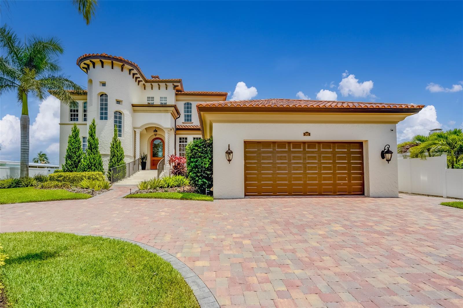 WELCOME to this STUNNING COASTAL WATERFRONT home on ST. PETE BEACH!. Newer construction (2007) built to Fema codes...High and Dry! This elegant 4 bedroom, 4 bathroom property showcases exquisite design and luxurious features throughout. Step into the gorgeous chef's kitchen, complete with custom cabinets, a gas range, large walk-in pantry, quartz countertops, and a spacious island perfect for entertaining. Adjacent to the kitchen is a stylish wet bar with a wine fridge, ideal for hosting guests and enjoying a glass of your favorite vintage. With hurricane impact glass throughout, this home offers both beauty and security. Upstairs, you'll find newly installed hardwood flooring that adds warmth and sophistication to the space. Custom drapery and window treatments further enhance the overall aesthetic. The newly remodeled media room is a true haven for relaxation, featuring a built-in bar with custom touches. This space is perfect for a man cave or a cozy spot to unwind after a long day. Step outside into the backyard and discover a tropical oasis. The salt water pool beckons you to take a refreshing dip, while the new sea wall and trex dock provide easy access to the water. Boating enthusiasts will appreciate the 30,000lb boat lift, designed to accommodate a large vessel. HVAC (2020), DOCK (2021), SEA WALL (2020), LIFT (2022). Located in close proximity to St. Pete Beach, this waterfront home offers the perfect blend of luxury, convenience, and coastal living. Don't miss the opportunity to make this your own private paradise.