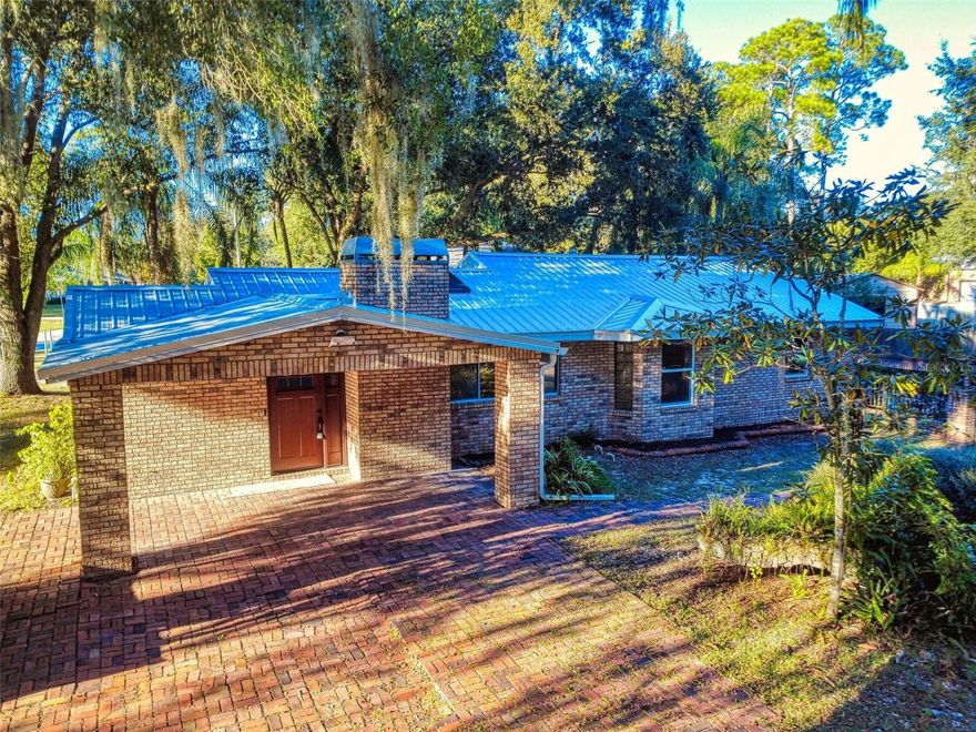 Rare opportunity! One of the few homes with an inground pool available in this price range—situated on an oversized, tropical lot in a highly desirable DeBary location just minutes from I-4, the Orlando Metro area, and the beaches. This all-brick home offers a flexible floor plan with potential for a 3rd bedroom conversion. The kitchen features granite countertops, solid wood cabinets, and stainless steel appliances. Additional highlights include a brand-new metal roof, a spacious indoor utility/laundry room, and multiple skylights that bring in plenty of natural light. No carpet—enjoy new wood laminate, ceramic tile, and brick flooring throughout. Step outside to your custom pool surrounded by brick decking and lush tropical landscaping. Priced right and ready for immediate occupancy!