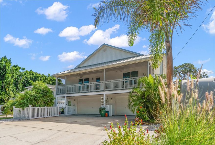 Looking for a slice of paradise? This STUNNING Key West styled home is calling your name!  Nestled in the highly desirable Indian Bluff Island neighborhood of Palm Harbor, Florida, this home has four bedrooms and two bathrooms upstairs, and a 400 square foot air-conditioned room and en-suite bathroom downstairs.  The downstairs flex space is simply incredible- with epoxy floors and air-conditioned parking for FOUR vehicles, laundry, bathroom, and a HUGE room that could be an office, home gym, or yoga studio, this space is awesome!  Upstairs, the breathtaking interior has been fully updated within the past two years, with flexible living spaces and a bright and airy floor plan, thanks to tons of natural light and recently installed hurricane rated windows, doors and skylights throughout. New luxury vinyl flooring and paint as well. In the kitchen, you’ll find solid wood cabinets with dovetail drawers, quartz countertops, and a suite of Bosch and Berazzoni appliances. An Aquasana whole-house water filtration system, renovated wood burning fireplace, completely rebuilt back deck to enjoy the stunning big sky sunrises and 30 amp RV outlet are a few amazing touches that will enhance your enjoyment of this home. And with a metal roof installed in 2019, you can rest easy knowing your home is built to last. Enjoy the Florida sunshine in your own backyard escape, with a modern saltwater pool, beautiful travertine deck, and screen enclosure installed in 2023. Or take a short stroll to the water to watch the dolphins play. Additionally, the Pinellas Trail is a third of a mile away, leading you to Wall Springs Park less than a mile from your door, and the round trip walk to Crystal Beach is about three miles. Imagine sipping sweet tea on the back porch in the morning, enjoying the trail or taking a bike ride in the afternoon, and then watching the sunset from the front porch at night, this home offers the ultimate Florida lifestyle.