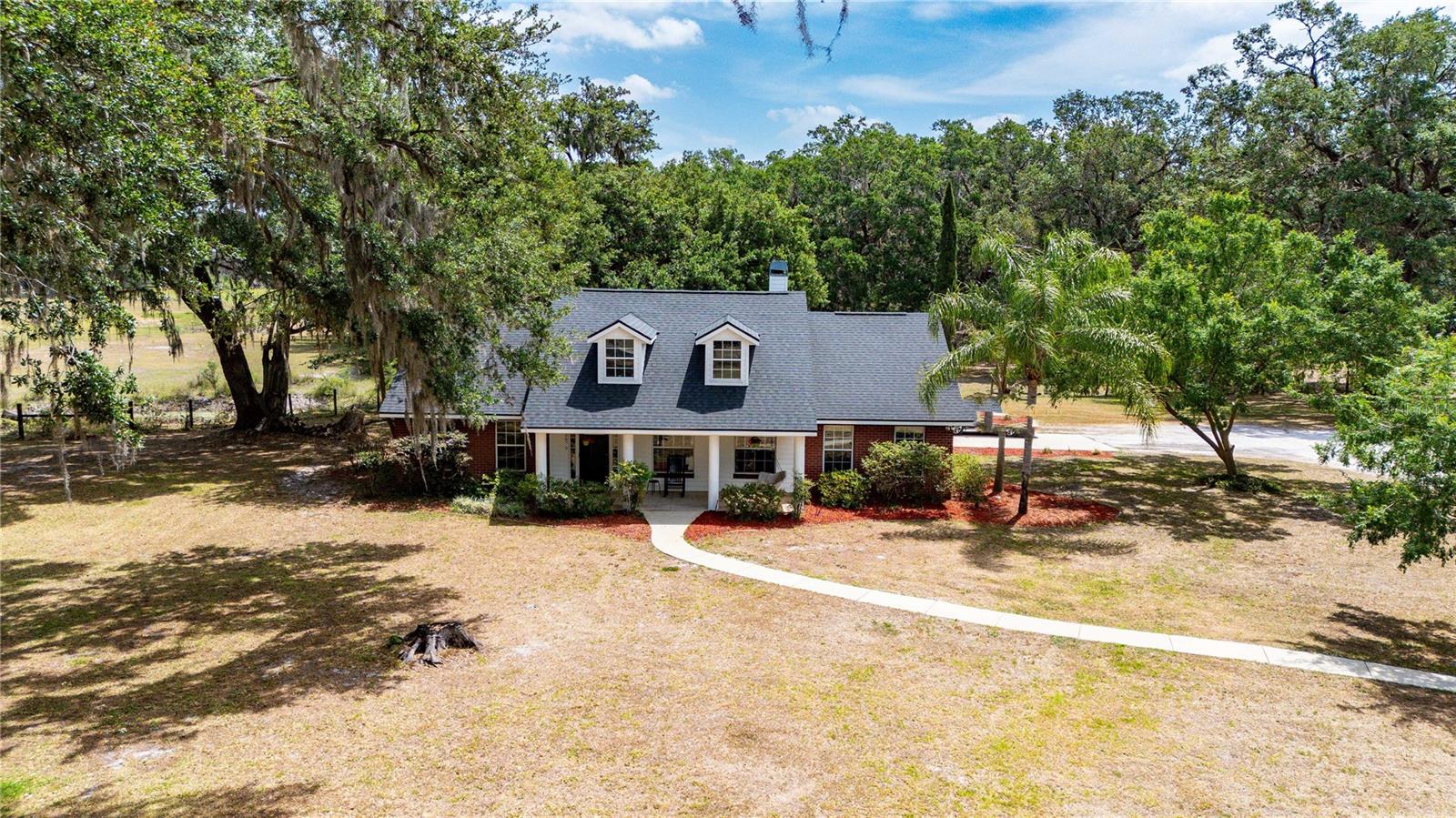 Welcome to your slice of country paradise! Nestled on 10.22 beautiful acres in peaceful Sumterville, this spacious 3-bedroom, 2-bath home offers the perfect blend of comfort, space, and versatility—with 2,055 square feet of living area and a bonus room that can easily be used as a 4th bedroom, craft room, man cave, or playroom to suit your lifestyle.
Step inside to find a freshly painted interior, filled with natural light and a layout that flows with ease. The home features a split floor plan with a large living space at the center of the home. The high ceilings and wood burning fireplace give this area the true feeling of luxury. The kitchen has corian counters, real wood cabinetry and stainless steel appliances. The master suite features a large walk-in closet and a spacious bathroom complete with a soaking tub and a separate walk-in shower, creating your own private retreat.
The back porch offers a true sanctuary with a 20 x 16 screened in area, perfect for relaxing or entertaining while you take in tranquil views of the surrounding property. Outside, you’ll find both a storage shed and a chicken coop—ideal for those wanting to embrace a little homestead living.
With a new roof installed in February, this home is move-in ready and waiting for you to make it your own.
Don’t miss the opportunity to own this unique property with room to grow, roam, and enjoy the peacefulness of country life—all while being just a short drive to nearby amenities.