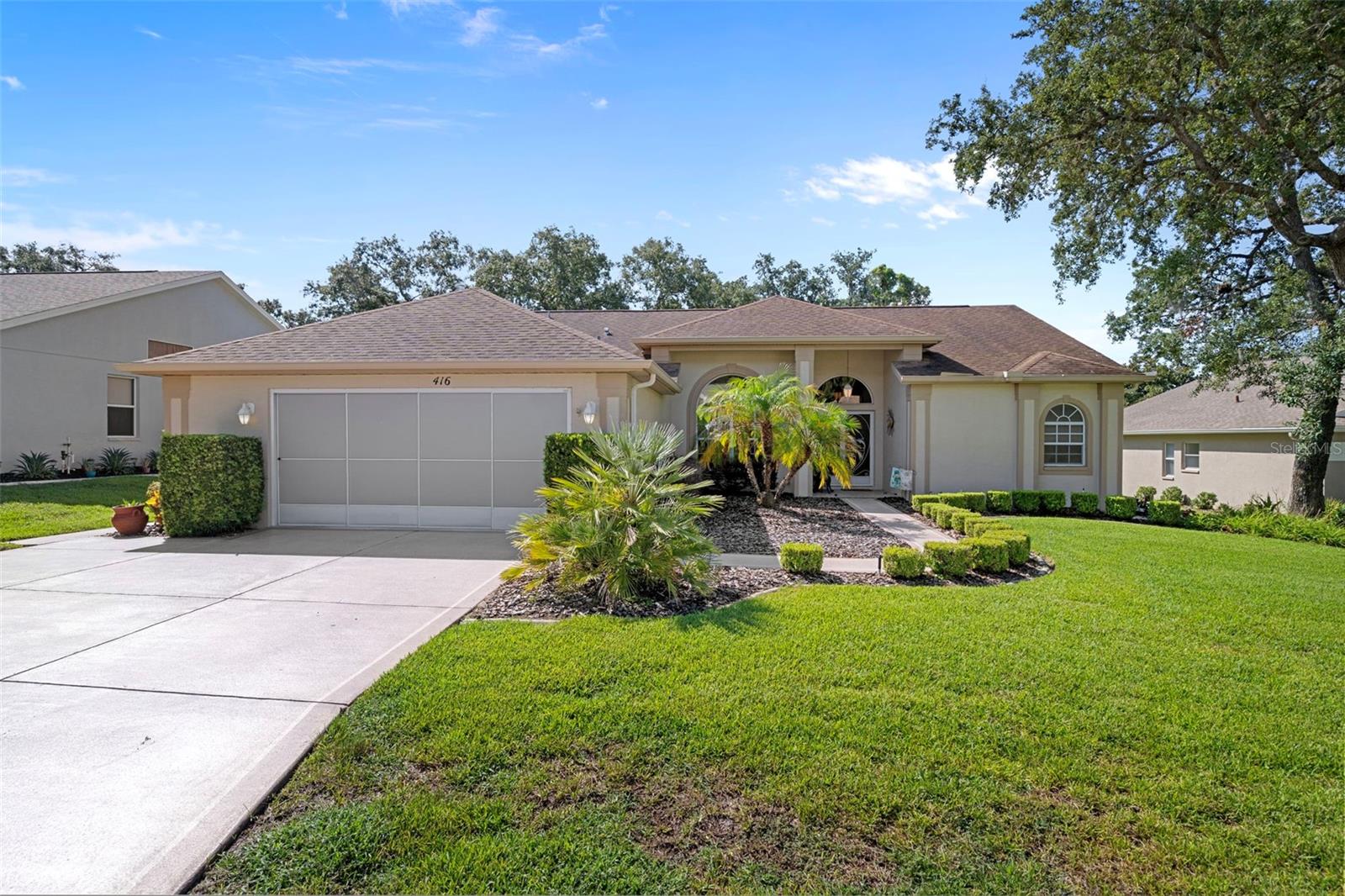Welcome to this beautifully updated and meticulously maintained single-family home located in the desirable Wellington 55+ Community. Pride of ownership is evident throughout this residence. As you approach, you’re welcomed by lush, beautiful landscaping and an elegant double-door entry. Inside, bright windows flood the formal living room with natural light, highlighting elegant wood-look tile that flows throughout the home. This area features triple sliding glass doors that lead to the lanai. The formal dining room, adorned with a modern chandelier, matches the entry light and complements the inviting atmosphere. Recently painted in designer colors, the interior also boasts a newer roof (2015), newer upgraded water filtration system for the entire home (2022), newer AC (2022), and brand-new gutters (2024). The kitchen is a chef’s dream with a gorgeous tray ceiling, recessed lighting, an abundance of beautiful cabinets, a breakfast bar with beautiful custom moldings, under-cabinet lighting, a large pantry, and stainless steel appliances that are just two years old. The bright family room, which opens to the kitchen, is perfect for entertaining and features sliding glass doors that lead to a large enclosed lanai with newer glass windows (2022) and upgraded blinds. A standout feature is the custom-built wooden deck that includes decorative railings and wide steps added in 2023, offering a serene spot to enjoy morning coffee while overlooking a meticulously manicured backyard. The luxurious Master Suite includes newer waterproof vinyl plank flooring, sliding glass doors to the lanai, and a 2 spacious walk-in closet both with California closet systems. The Master Bathroom is Gorgeous and features dual sinks with new faucets, updated fixtures, a gorgeous custom-tiled garden tub, and a beautifully tiled step-in shower with custom made glass doors and a glass enclosure. The spacious guest bedroom currently serves as an office with custom cabinetry, including a beautiful custom made desk. The guest bathroom has a newer toilet, elegant vanity including a sink with a newer faucet, and custom-tiled gorgeous step-in shower with custom made glass enclosure and glass shower doors. A spacious third bedroom is perfect for guests with a new fan/light and a large closet with a California closet system. Additionally, the spacious inside laundry room comes equipped with newer ( two years old ) front-loading washer and dryer that are included in the sale, an abundance of beautiful cabinets and a large sink. Ideally located just a short stroll from the community clubhouse and pool, this home offers comfort, convenience, and elegant Florida living at its finest. Located in the Wellington, an amazing 55+ community featuring a 24-hour guarded gate ensuring security & peace of mind for residents. There are 6 pickleball courts, tennis courts, bocce, billiards, Olympic-sized swimming pool & spa, yoga, line dancing, shuffleboard & horseshoes. Social & community spaces include a clubhouse, Wellington's Bar & Grill Restaurant, a fitness center, library, business center with computer stations, arts & crafts studio, ballroom & meeting rooms. The Wellingtons HOA fee includes high-speed fiber optic internet connection with Wi-Fi and Spectrum TV & access to the full recreational amenities. The Wellington is located close to the Suncoast Parkway, Shopping, Dining, Doctors and Hospitals. Priced to sell quickly for only $364,900.